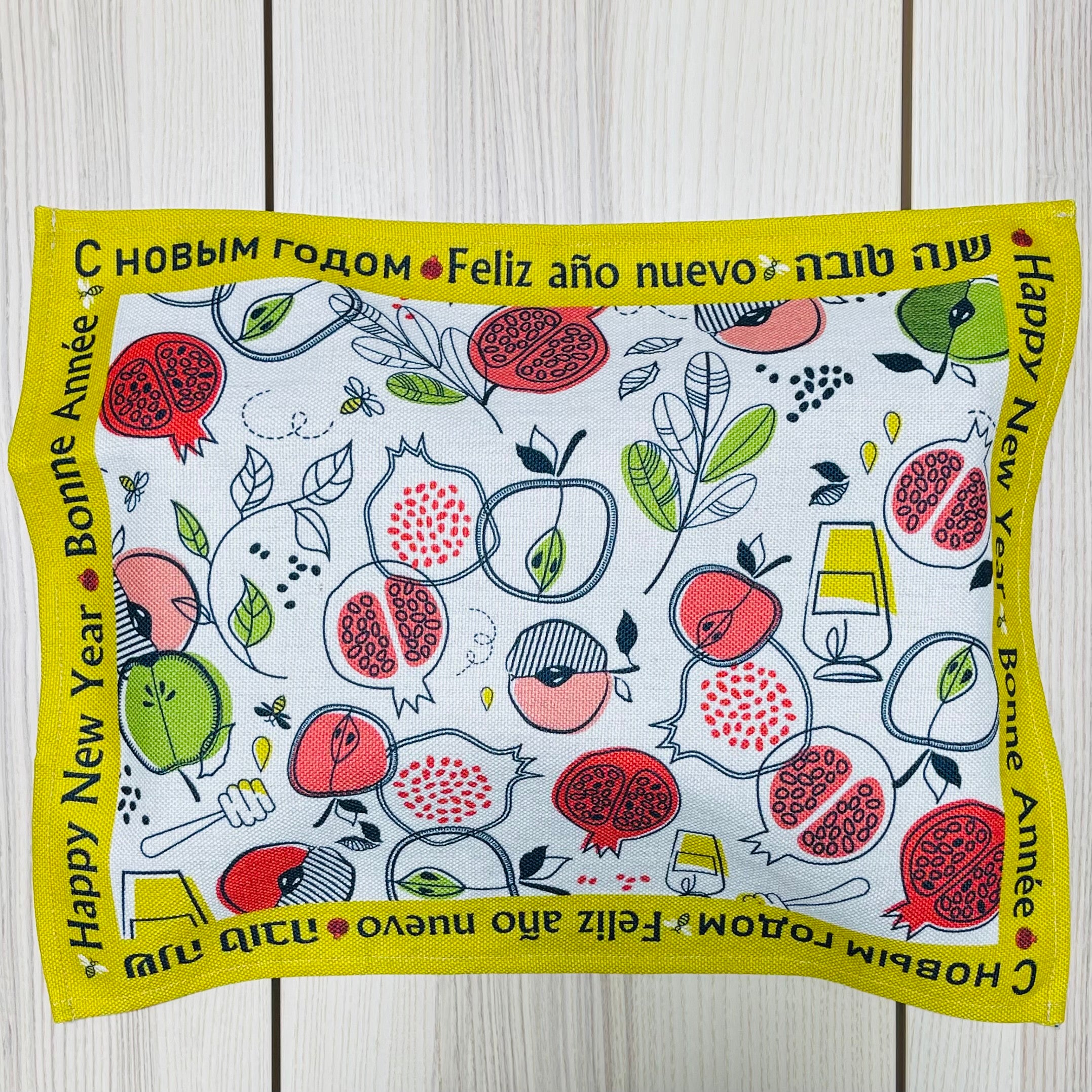 A beautifully designed Pomegranate Challah Cover featuring colorful Rosh Hashana symbols and 'Shana Tova' in elegant calligraphy.