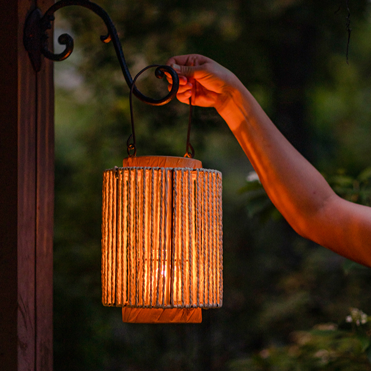 Portable Lantern Candle Holder in natural khaki color, featuring a hemp body and metal handle, perfect for indoor and outdoor decor.