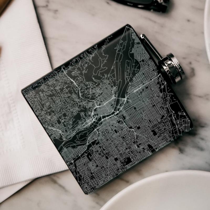 Custom engraved matte black hip flask featuring a detailed map of Portland, Oregon with coordinates.