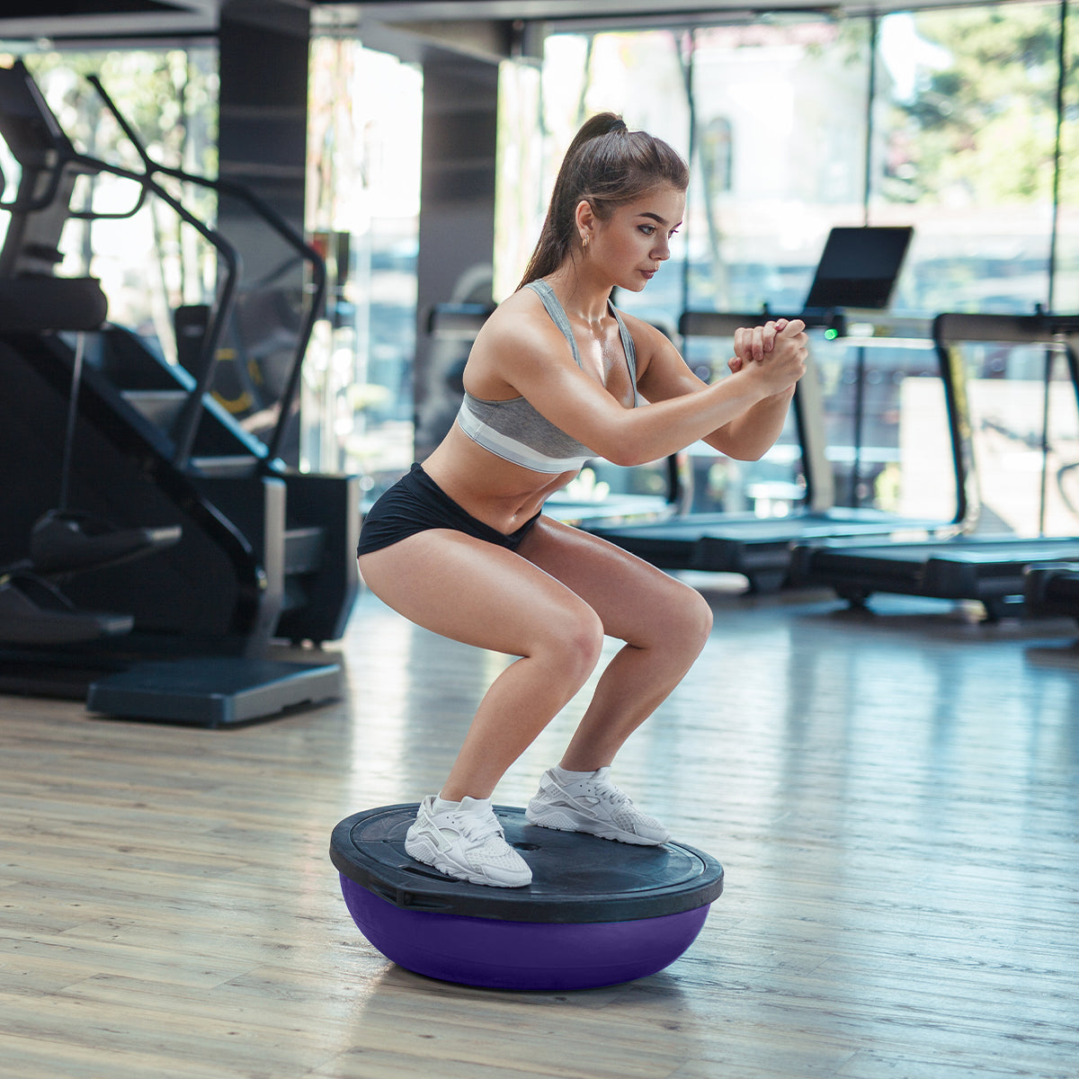 Powertrain Fitness Yoga Ball in purple, 58cm size, featuring a flat side for stability and a dome for balance exercises, with resistance band and pump.