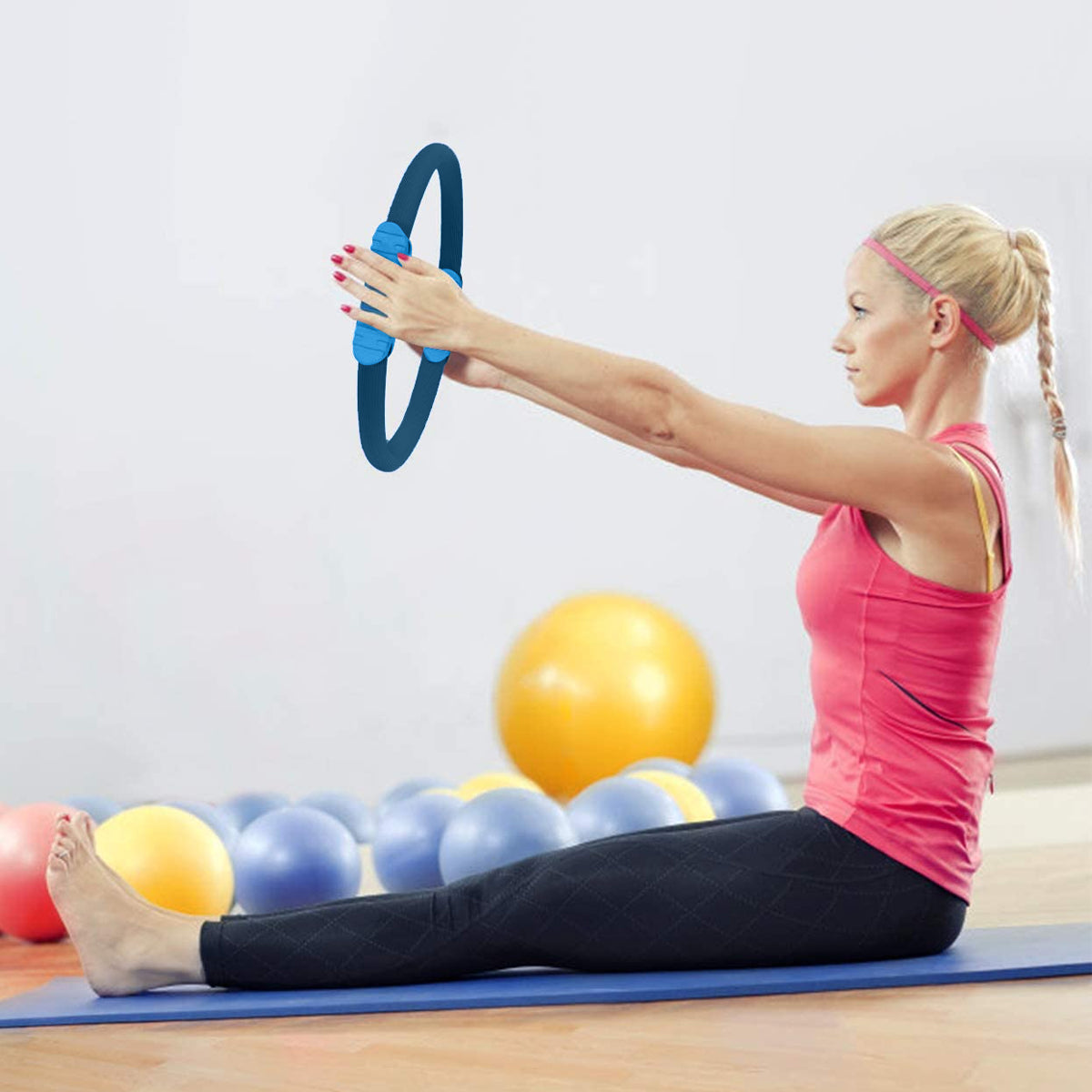 Powertrain Pilates Ring Band in blue color with soft foam handles, ideal for home workouts and muscle toning.