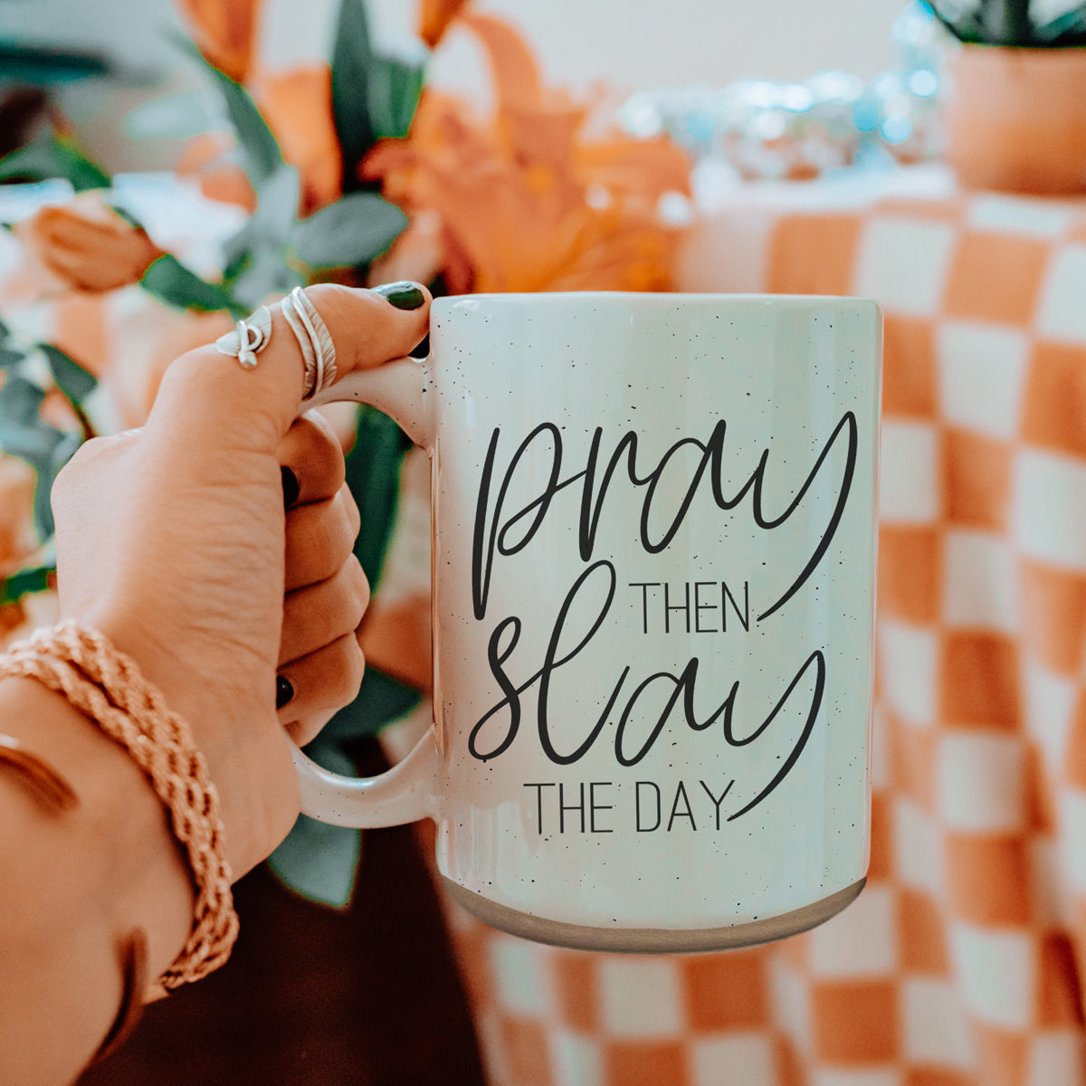 Pray + Slay 16oz ceramic mug with black graphic design on both sides, off-white color with dark speckles.