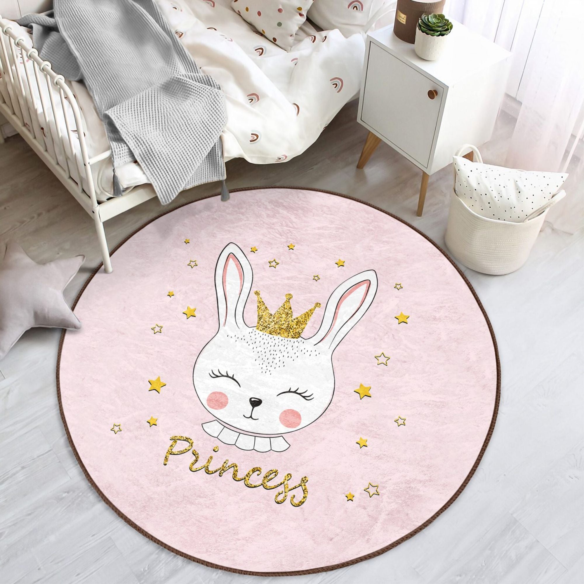 A pink washable rug featuring a cute princess rabbit pattern, perfect for kids' rooms, showcasing vibrant colors and soft texture.