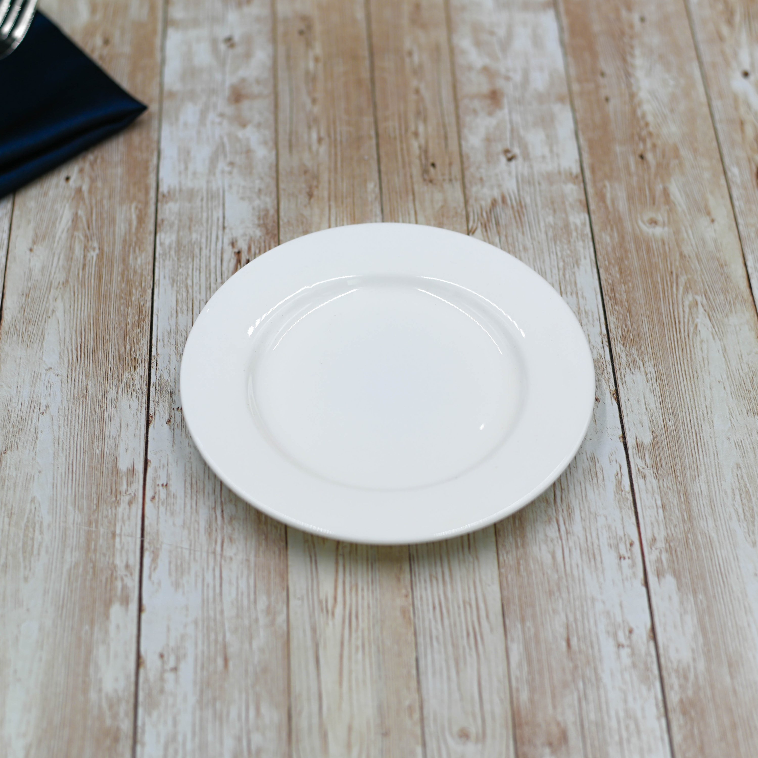 A 6-inch Professional Rolled Rim White Bread Plate made of fine porcelain, showcasing its elegant snow-white finish and rolled rim design.