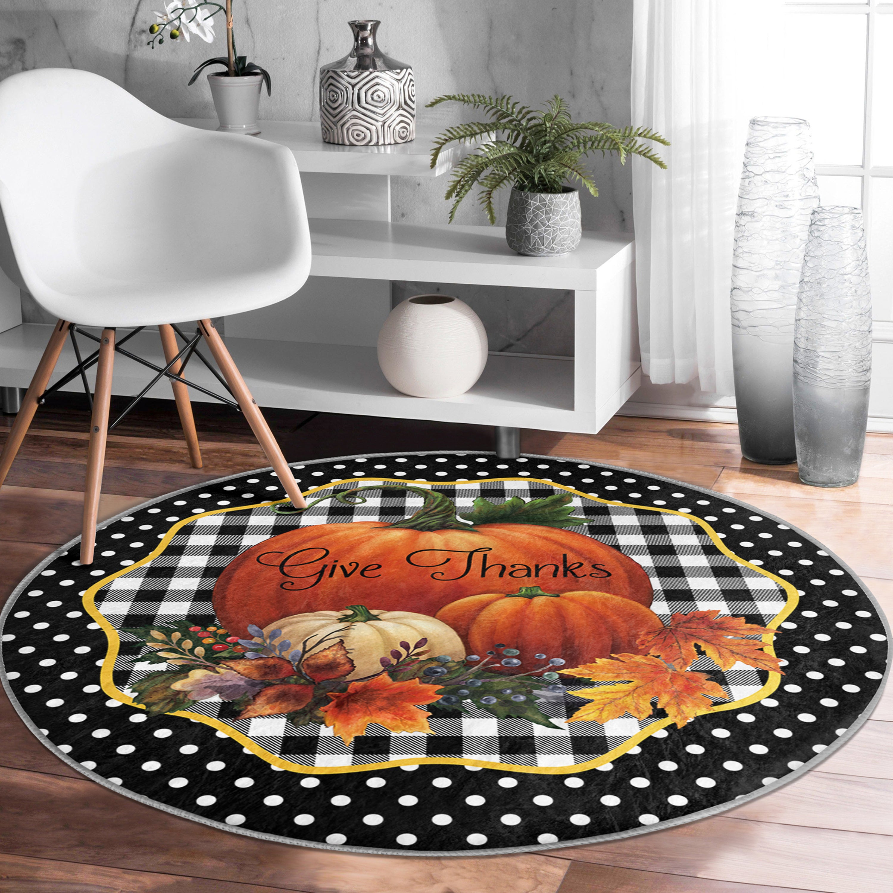 A round rug featuring a vibrant pumpkin pattern, made of soft velvet fabric, perfect for living room decor.