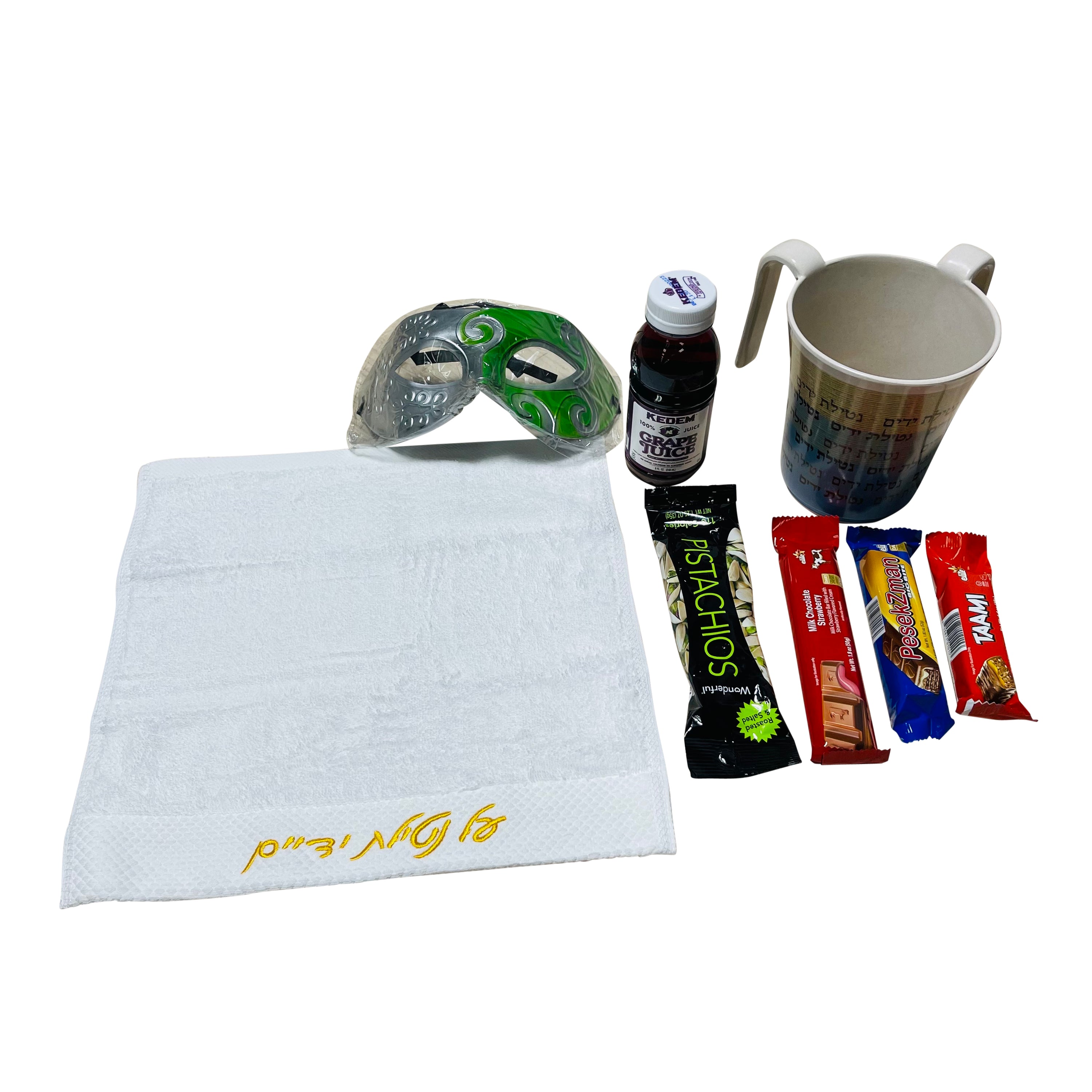 A beautifully arranged mishloach manot for Purim, featuring a bamboo washing cup, hand towel, grape juice, chocolate bars, pistachios, and a plastic mask.