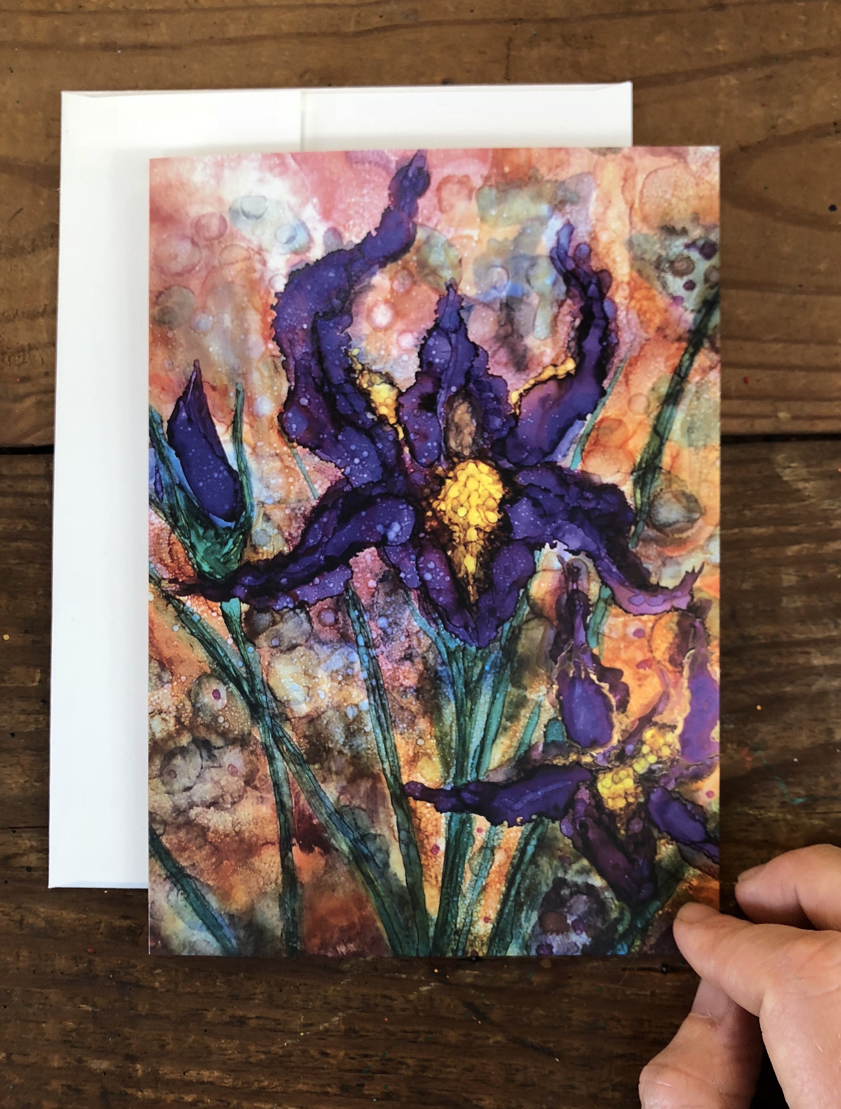 A beautifully designed greeting card featuring vibrant purple irises against a detailed background, showcasing intricate details and soothing colors.