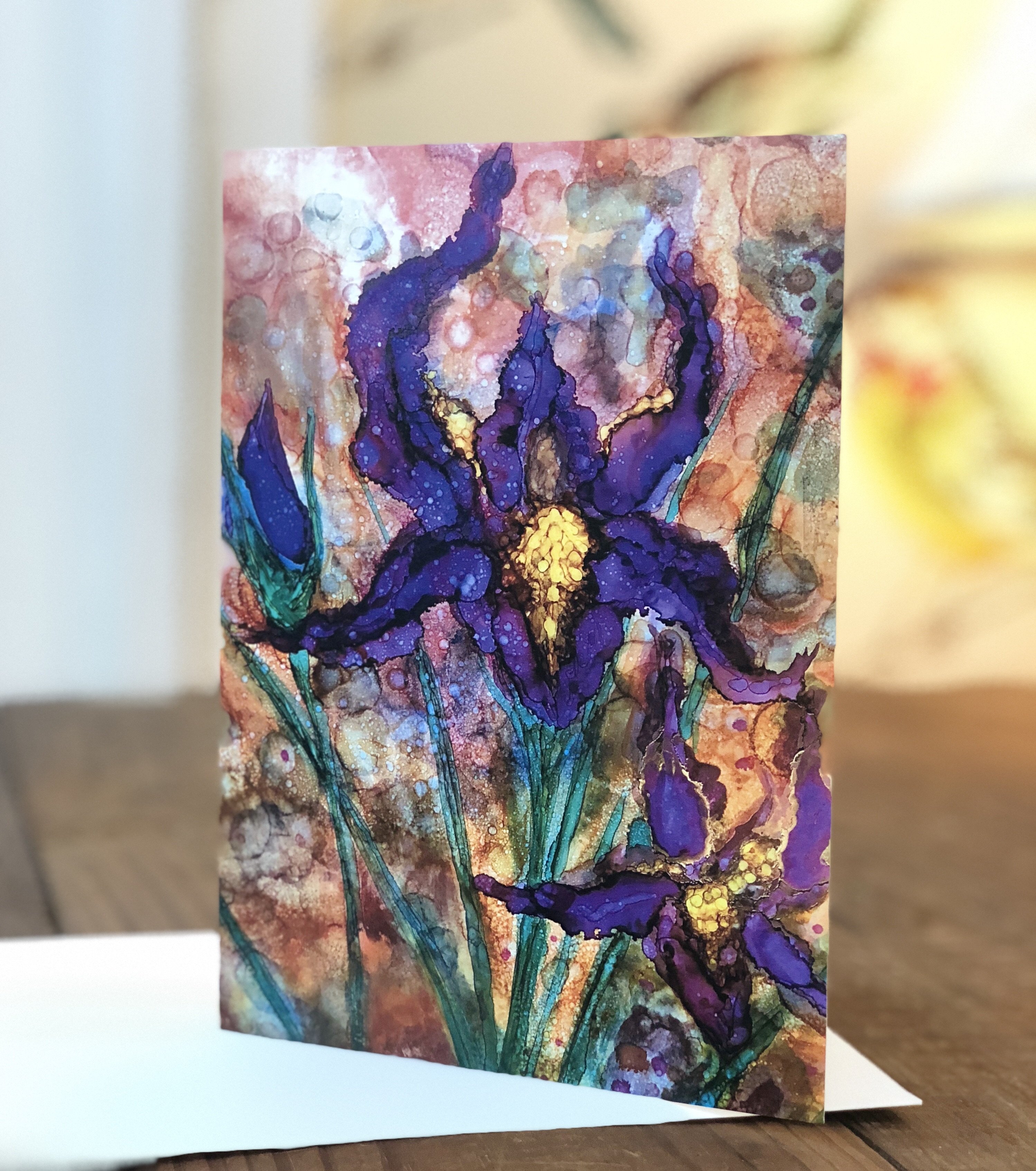 A beautifully designed greeting card featuring vibrant purple irises against a detailed background, showcasing intricate details and soothing colors.