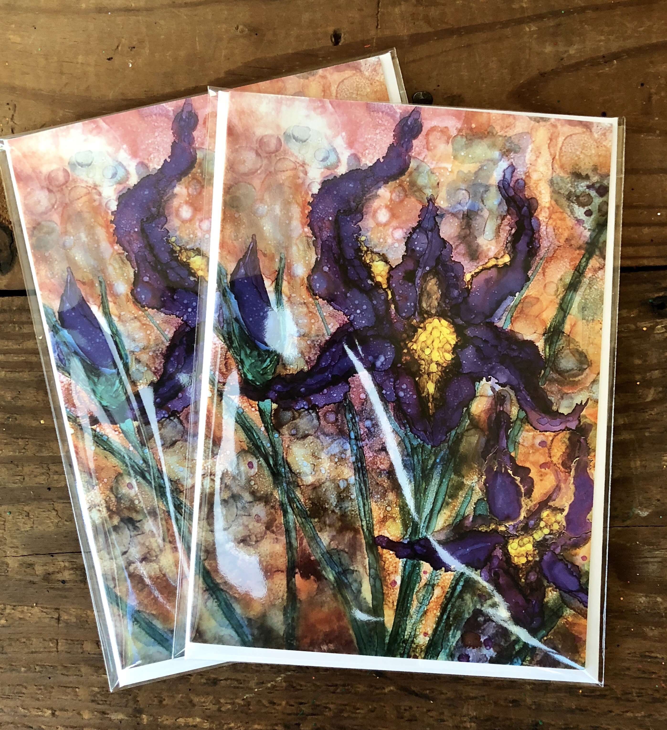 A beautifully designed greeting card featuring vibrant purple irises against a detailed background, showcasing intricate details and soothing colors.