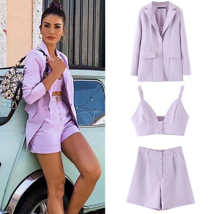 A stylish purple three-piece suit for women, featuring a small suit top and straight leg pants, showcasing a trendy splicing design.