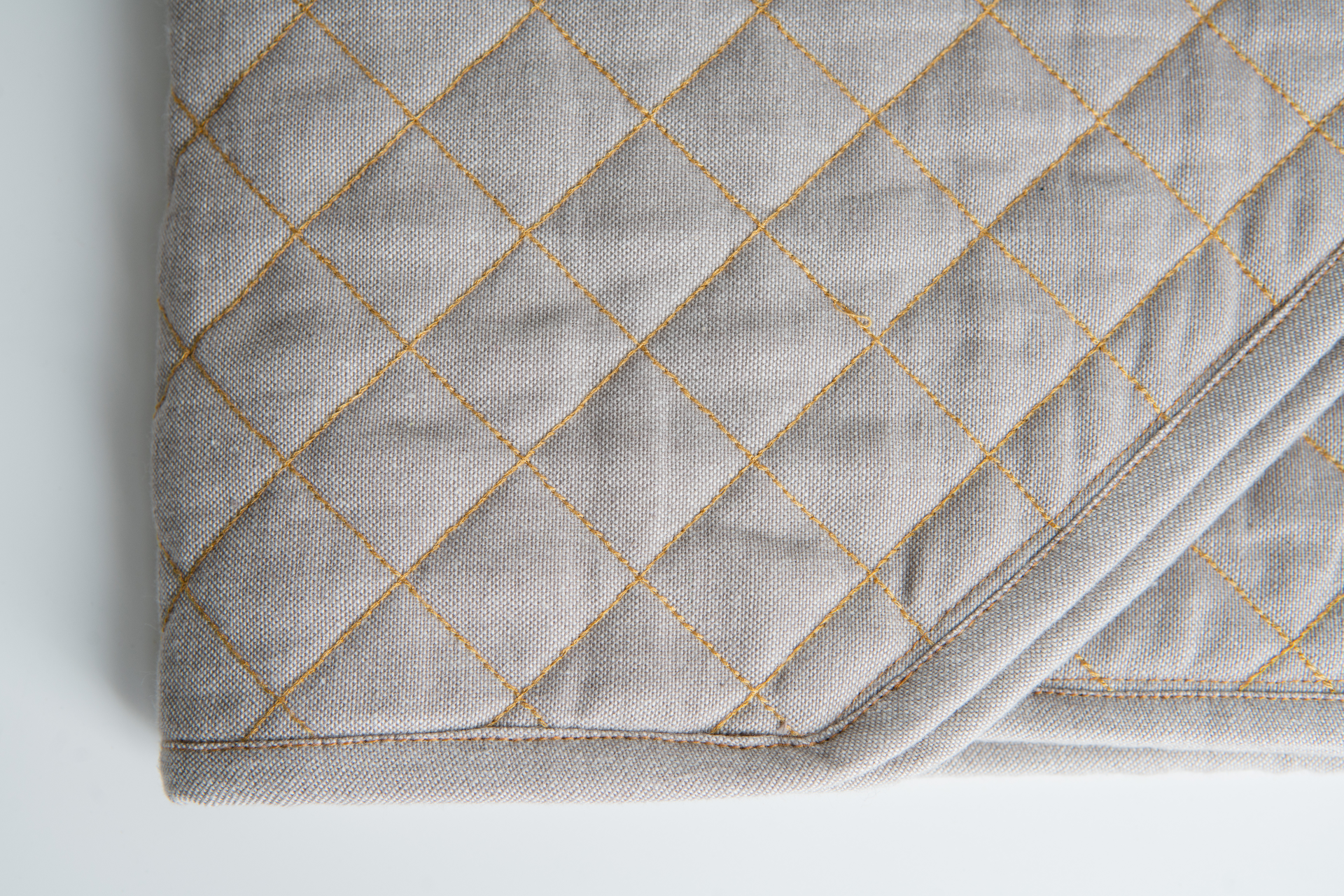 Organic Cotton Quilted Table Runner in luxurious chambray weave, perfect for stylish dining settings.