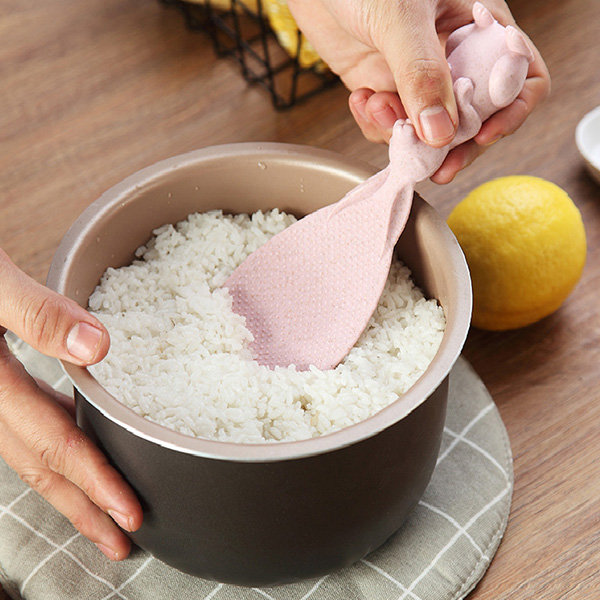 Scooping rice with pink spatula.