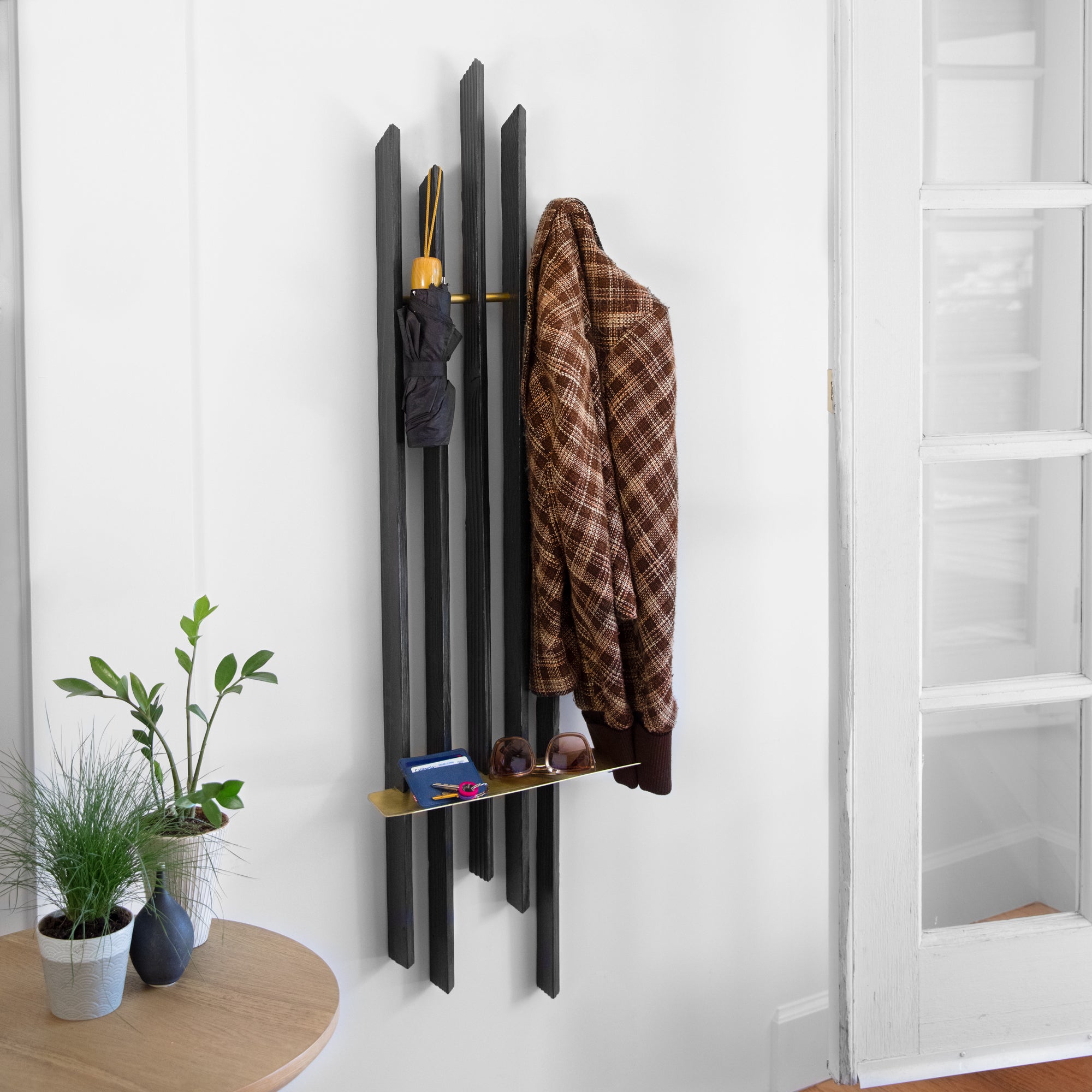 Rack On coat rack featuring hooks and a brass tray, made from reclaimed wood with a torched black finish.