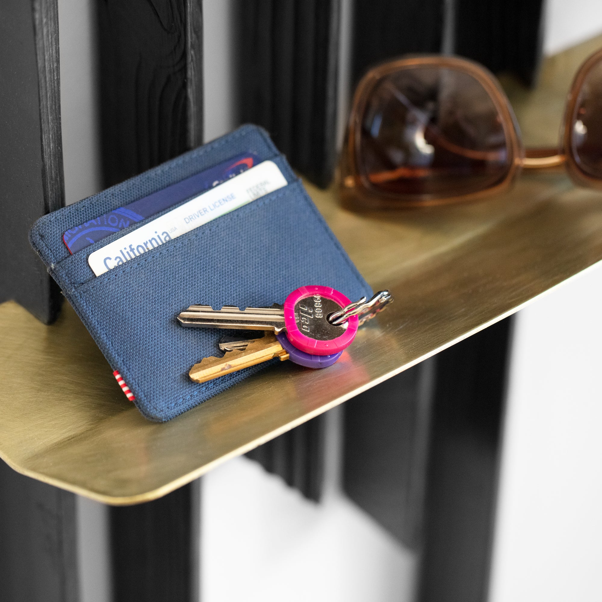 Rack On coat rack featuring hooks and a brass tray, made from reclaimed wood with a torched black finish.