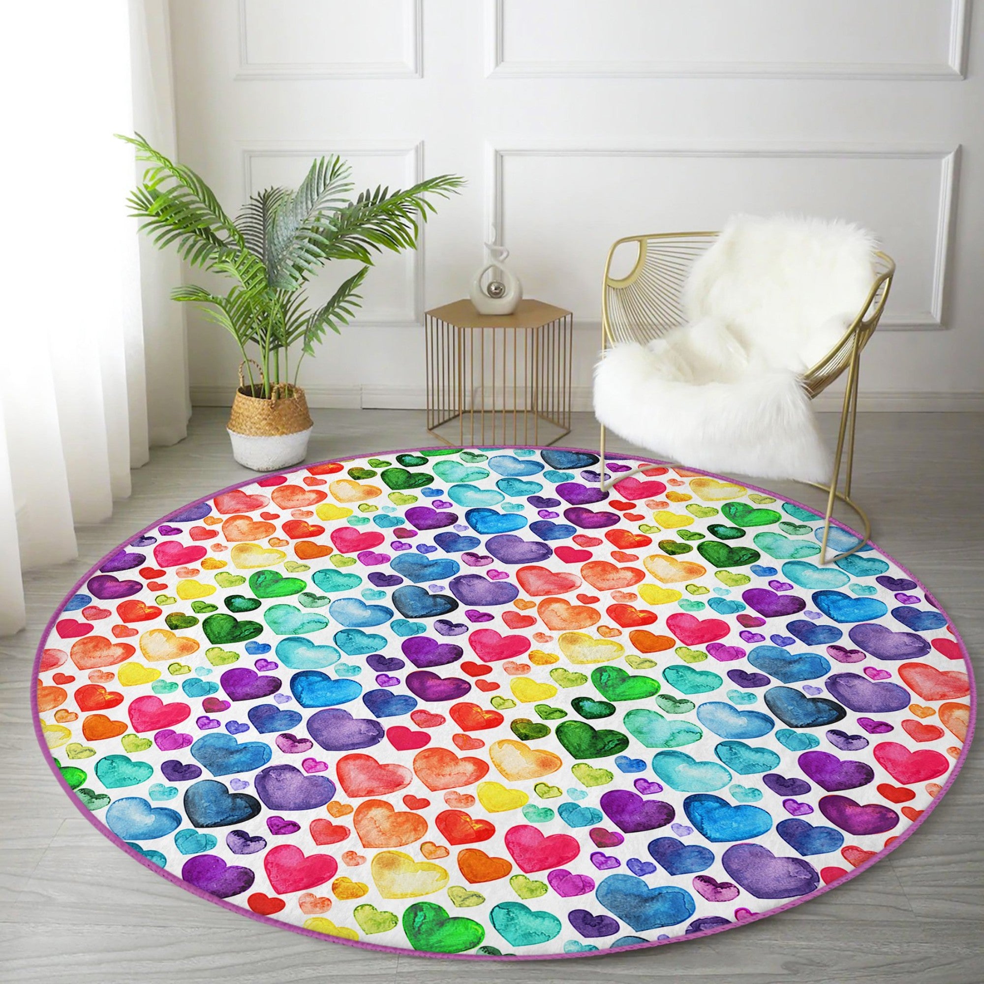 A colorful round rug featuring a vibrant rainbow heart pattern, perfect for home decor.