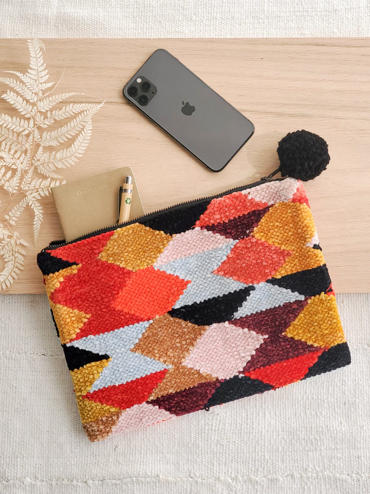 Rana Clutch made from recycled chenille fabric, featuring vibrant colors and unique patterns, perfect for fall and winter.