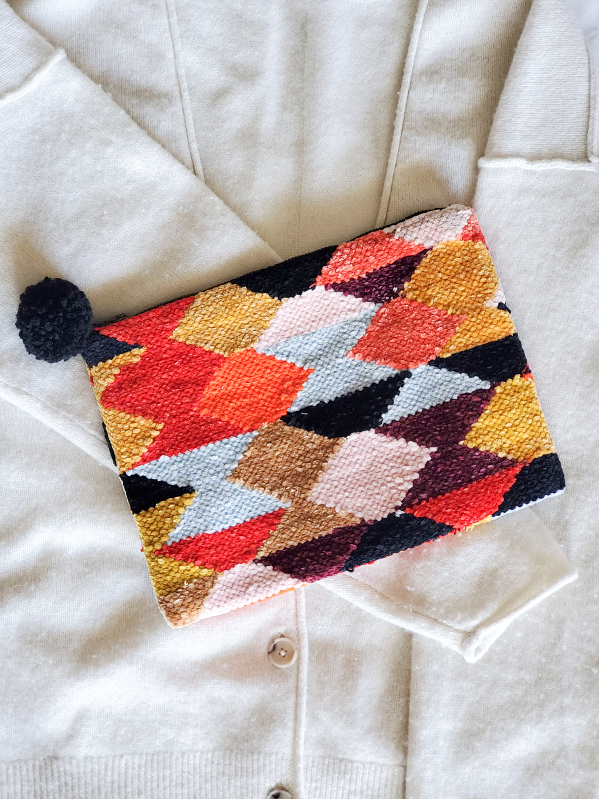 Rana Clutch made from recycled chenille fabric, featuring vibrant colors and unique patterns, perfect for fall and winter.