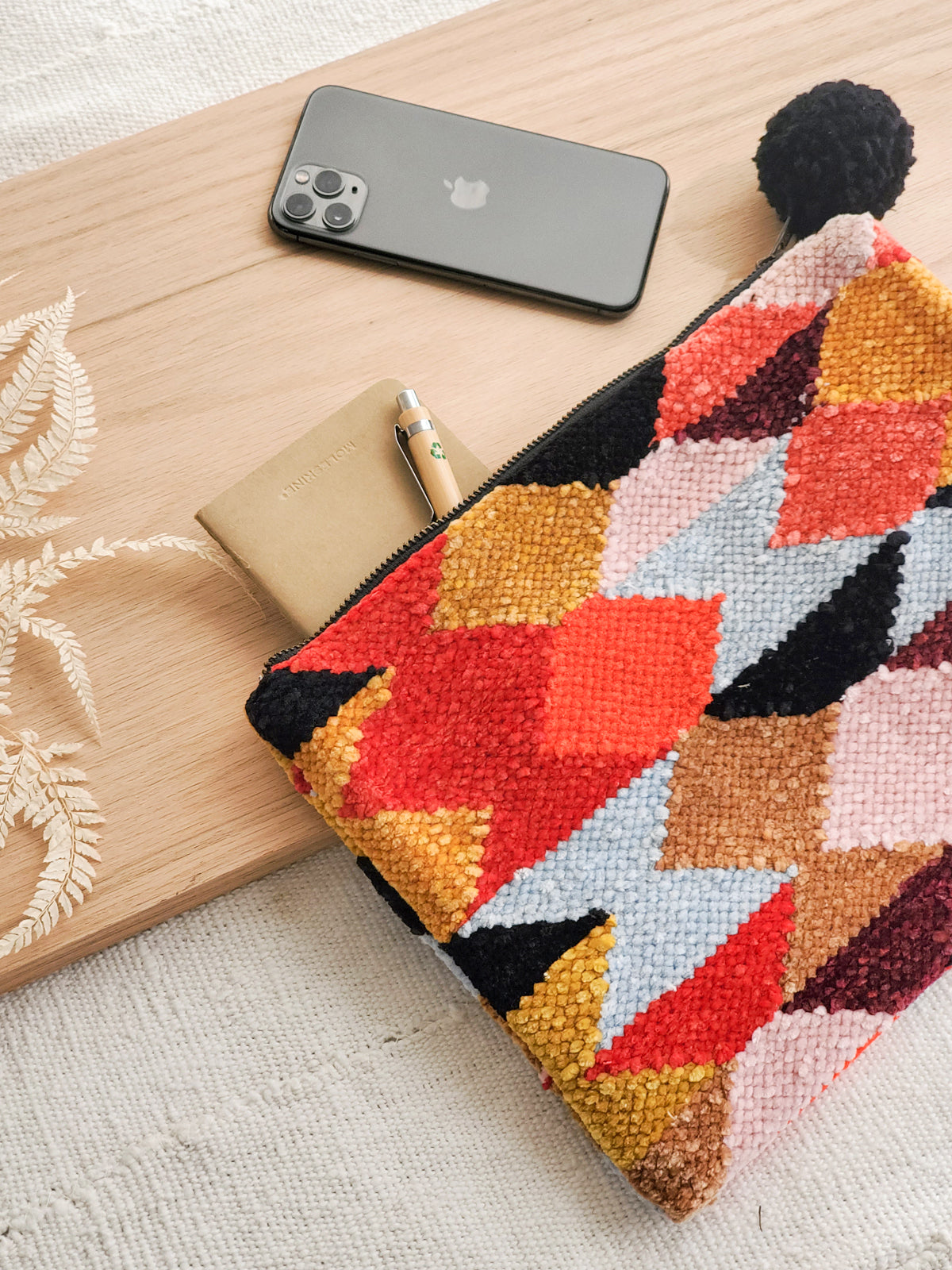 Rana Clutch made from recycled chenille fabric, featuring vibrant colors and unique patterns, perfect for fall and winter.