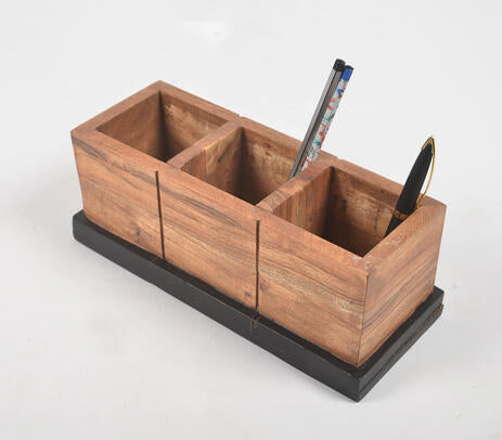 A beautifully crafted raw wooden pen stand with three slots, showcasing natural wood texture and irregularities, perfect for organizing stationery.