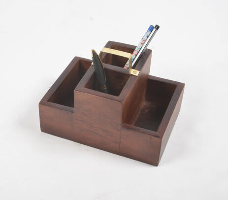 A handmade raw wooden desk organizer with four slots, showcasing unique textural variations and a natural finish, perfect for organizing stationery.