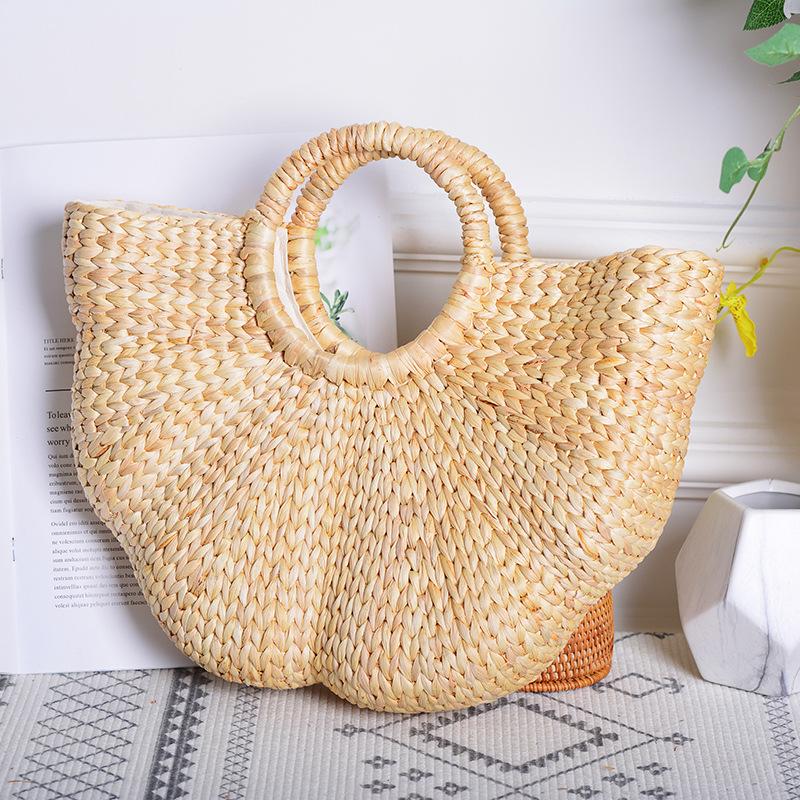 Realer woven straw bag for women, featuring a stylish half-moon shape and hollow-out design, perfect for summer beach outings.