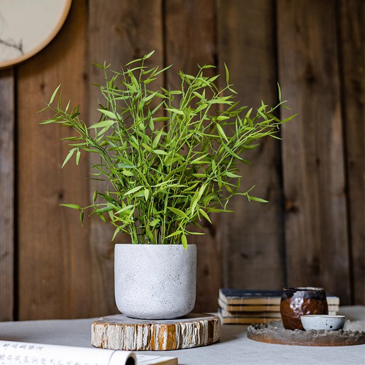 Realistic Mini Bamboo Leaf Potted Plant in a light gray pot, showcasing vibrant green leaves and a lifelike appearance.