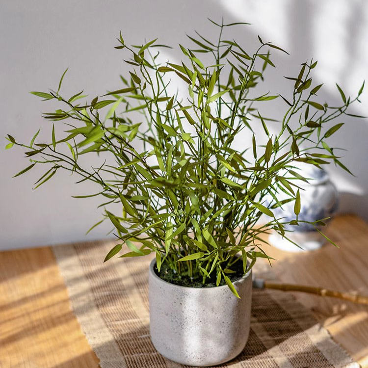 Realistic Mini Bamboo Leaf Potted Plant in a light gray pot, showcasing vibrant green leaves and a lifelike appearance.