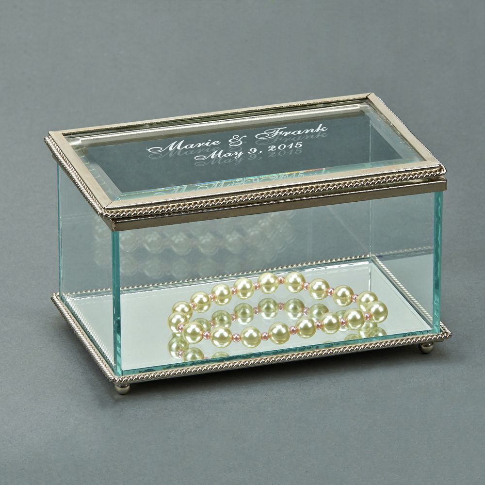 Elegant rectangular glass box with hinged cover and braided border, featuring a mirror bottom and four ball feet.