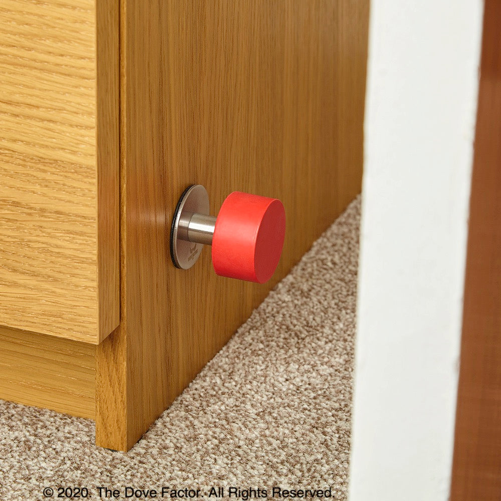 Red Door Stop with 3M Adhesive by The Dove Factor, showcasing its sleek stainless steel design and rubber cushioning.