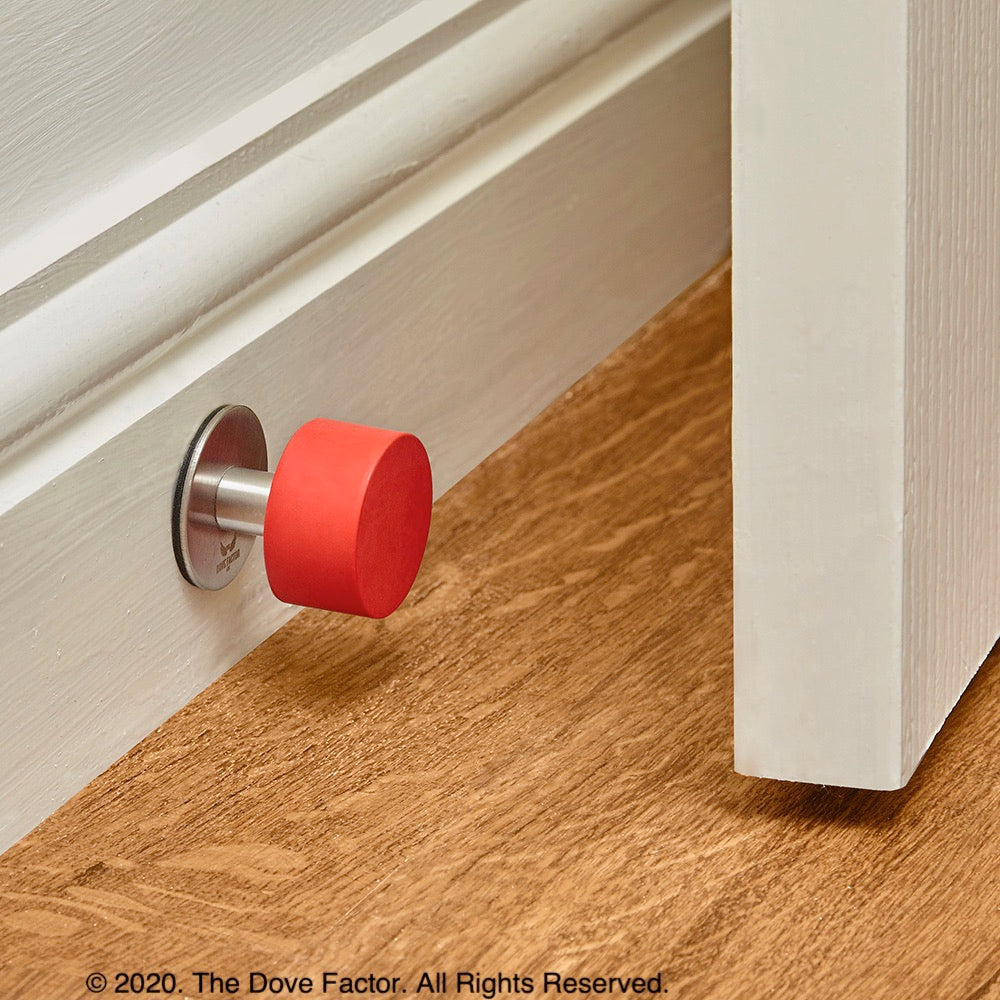 Red Door Stop with 3M Adhesive by The Dove Factor, showcasing its sleek stainless steel design and rubber cushioning.