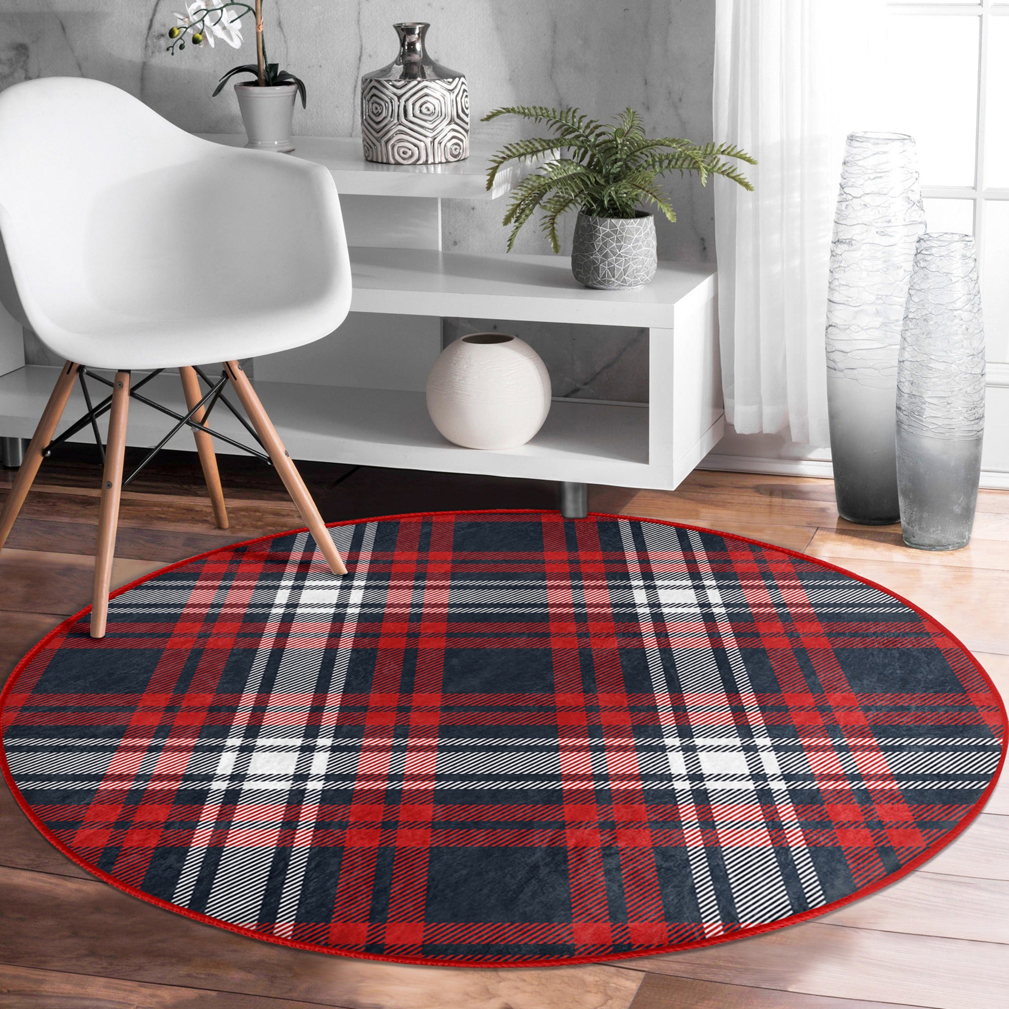 A cozy round rug featuring a vibrant red plaid pattern, perfect for home decoration.