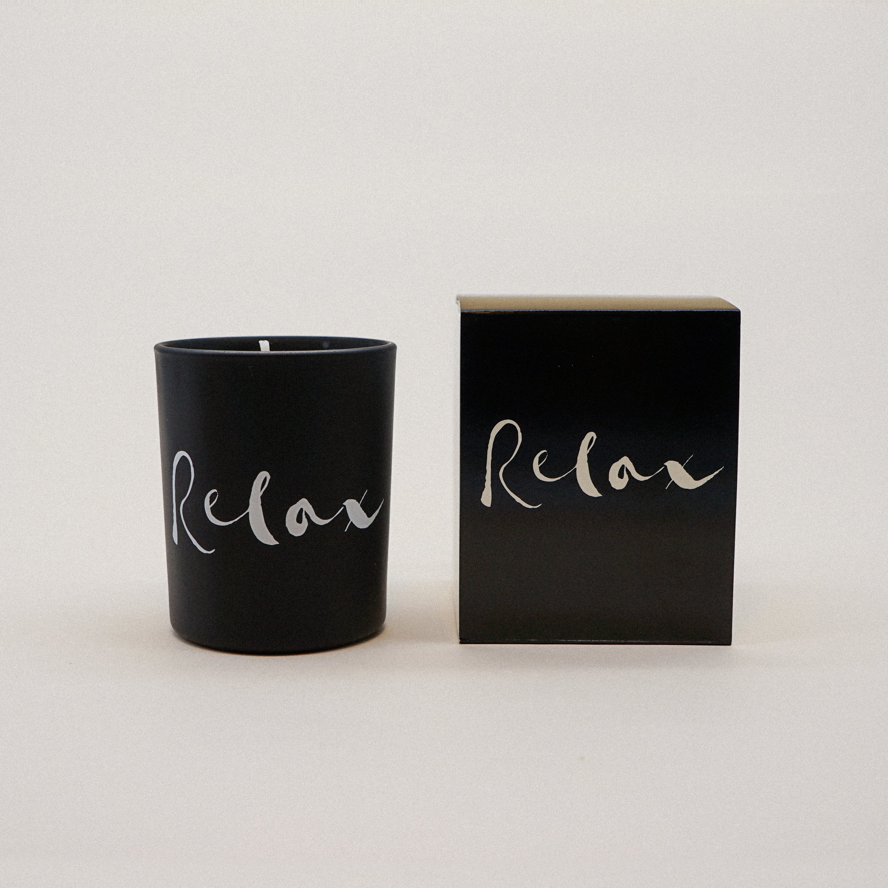 Relax Natural Wax Candle in black glass with brush painting design, showcasing its elegant and soothing appearance.