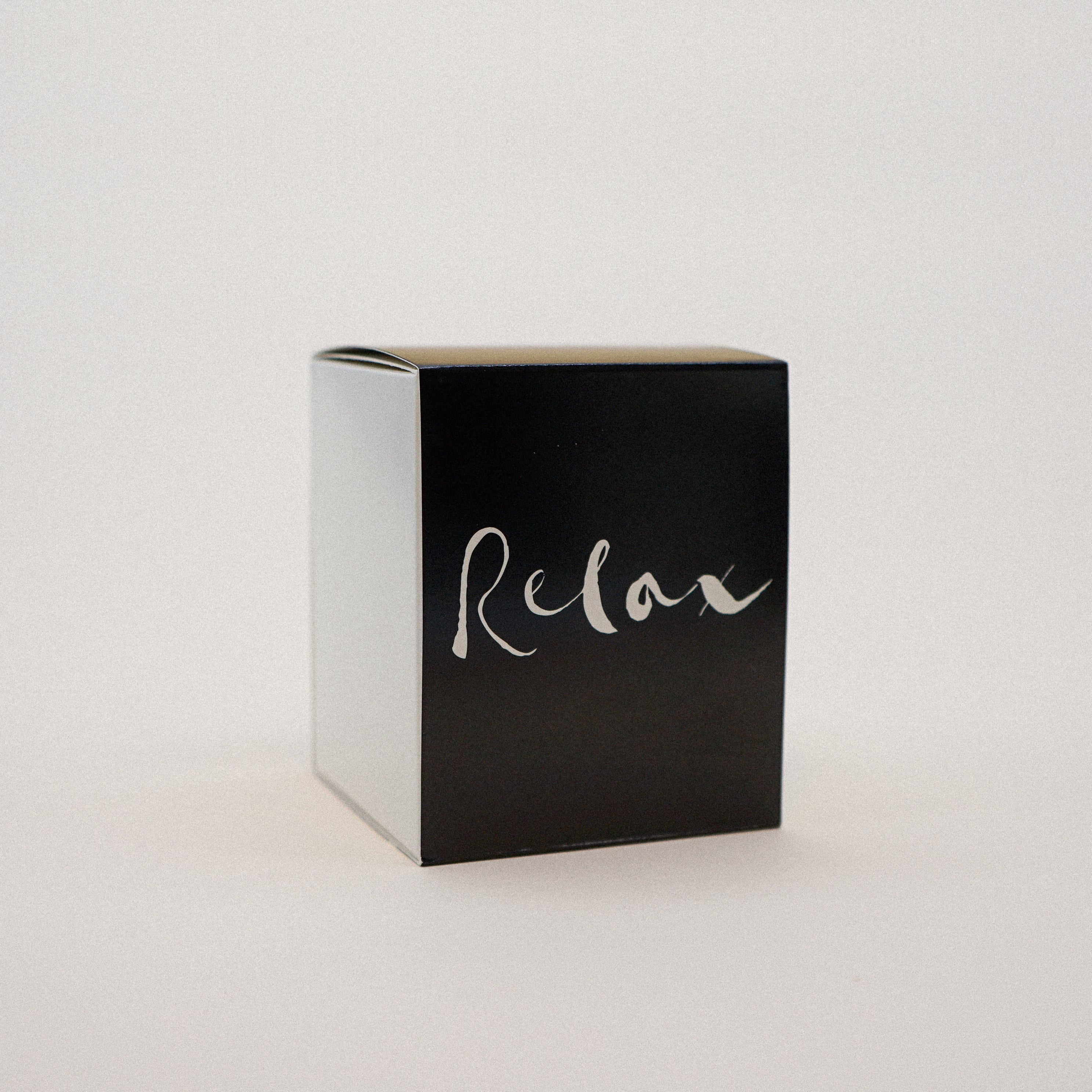 Relax Natural Wax Candle in black glass with brush painting design, showcasing its elegant and soothing appearance.