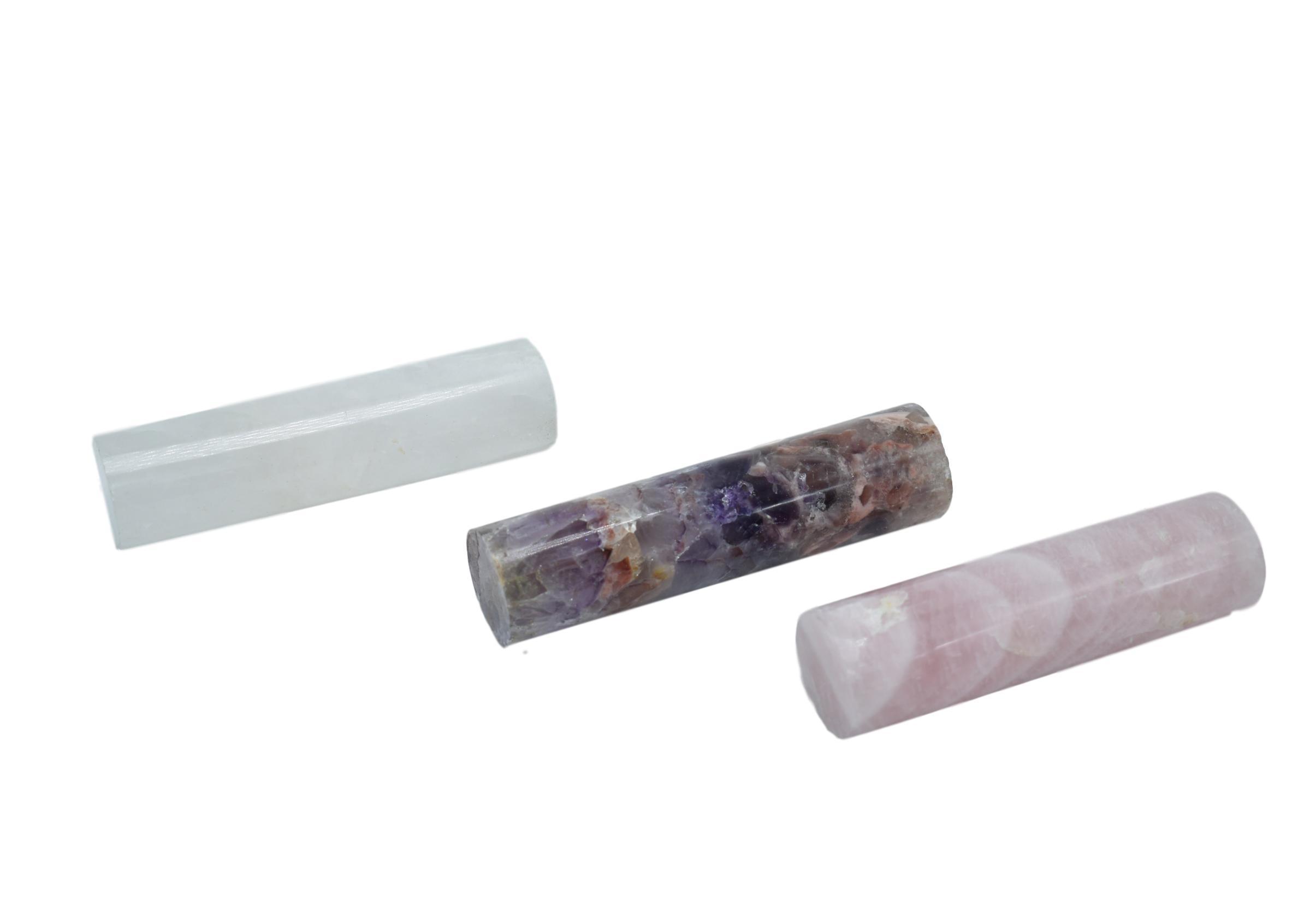 A collection of 4-inch gemstone rods made from amethyst, rose quartz, and clear quartz, showcasing their natural beauty and vibrant colors.