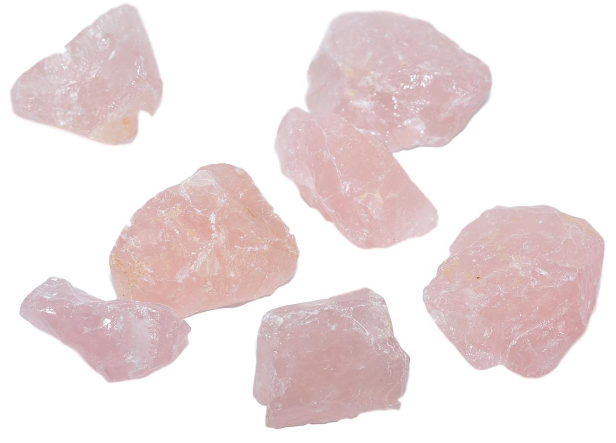 A collection of rose quartz chunks in various sizes, showcasing their soft pink hue and natural beauty.