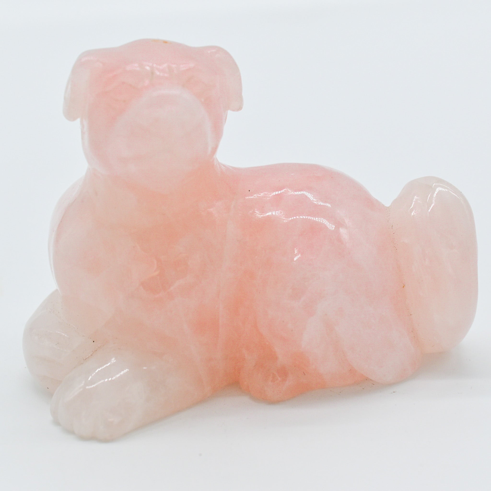 A beautifully handcrafted rose quartz dog carving, showcasing intricate details and a polished finish, perfect for dog lovers.