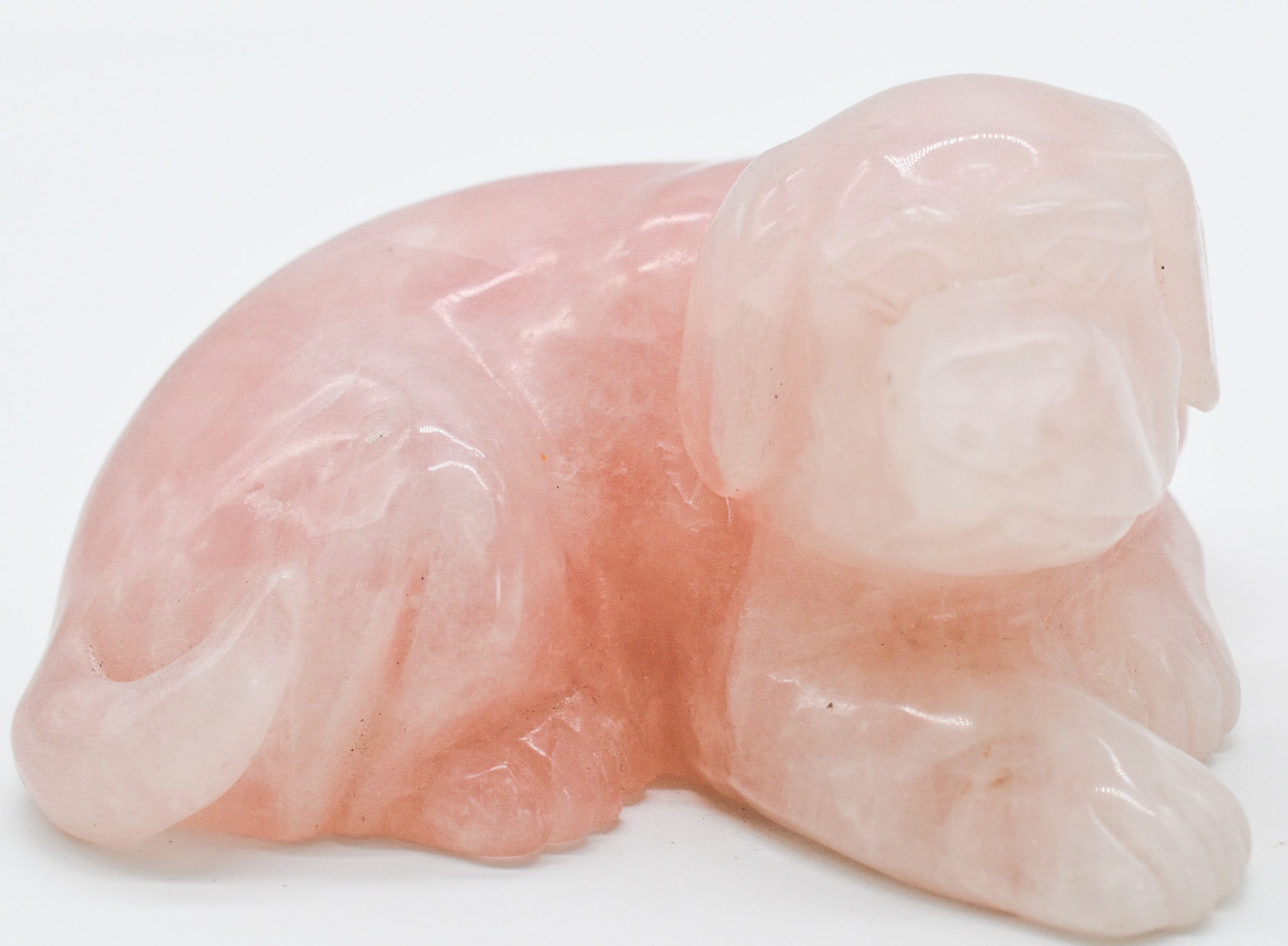 A beautifully handcrafted rose quartz dog carving, showcasing intricate details and a polished finish, perfect for dog lovers.