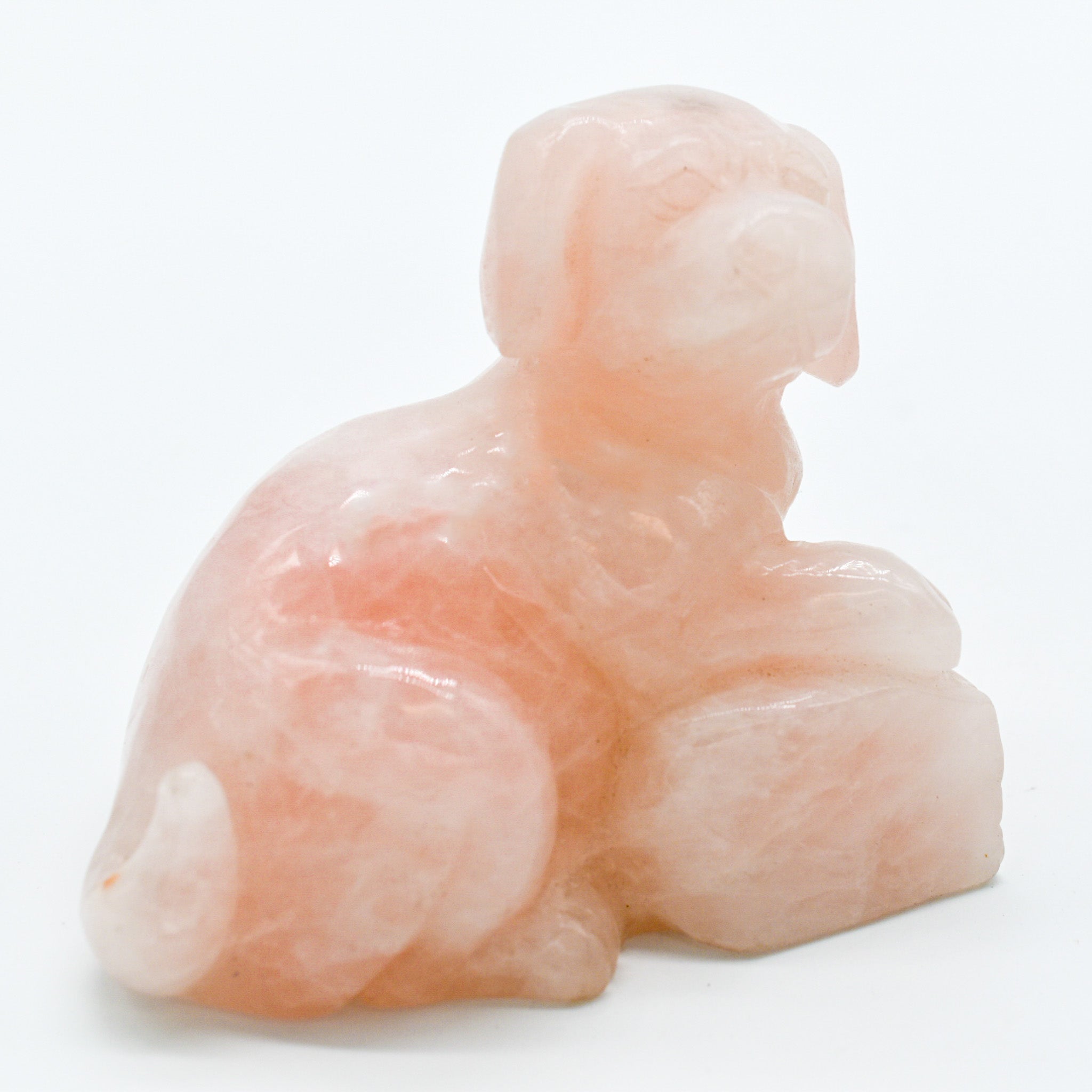 A beautifully handcrafted rose quartz dog carving, showcasing intricate details and a polished finish, perfect for dog lovers.