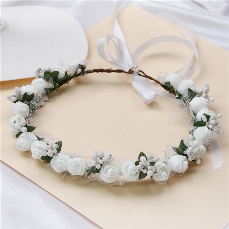 A beautiful handmade rose wreath flower crown, perfect for weddings, featuring delicate roses in a bohemian style.