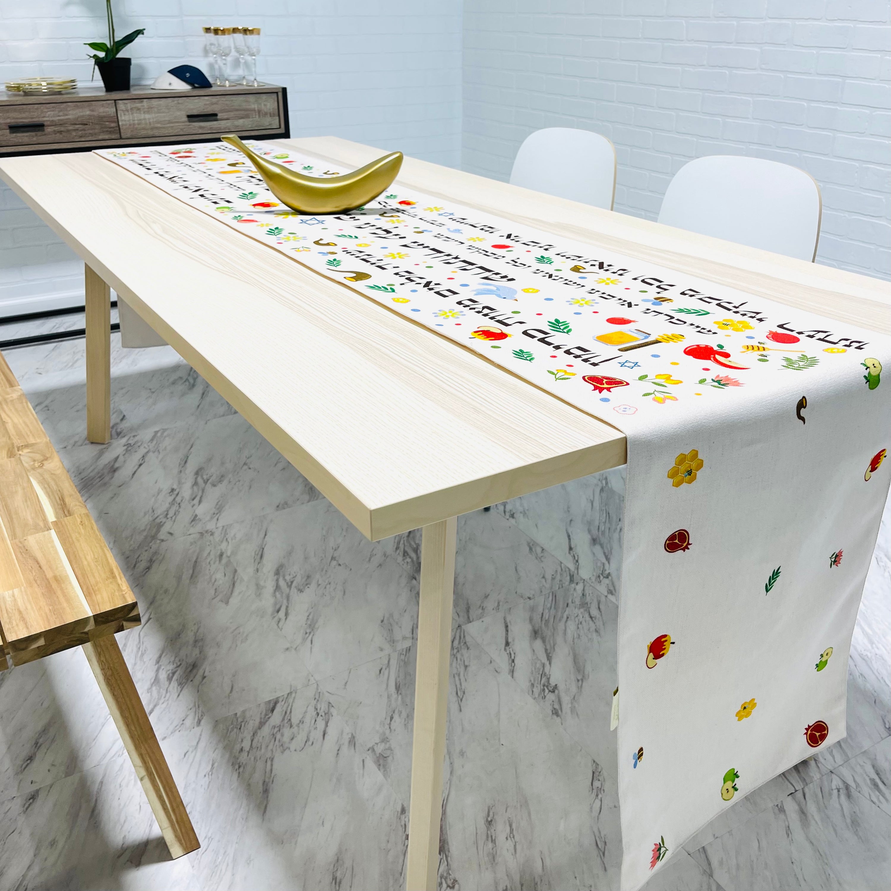 Festive Rosh Hashanah table runner featuring pomegranates, apples, honey, shofars, doves, and Hebrew blessings, made from cotton-linen blend.