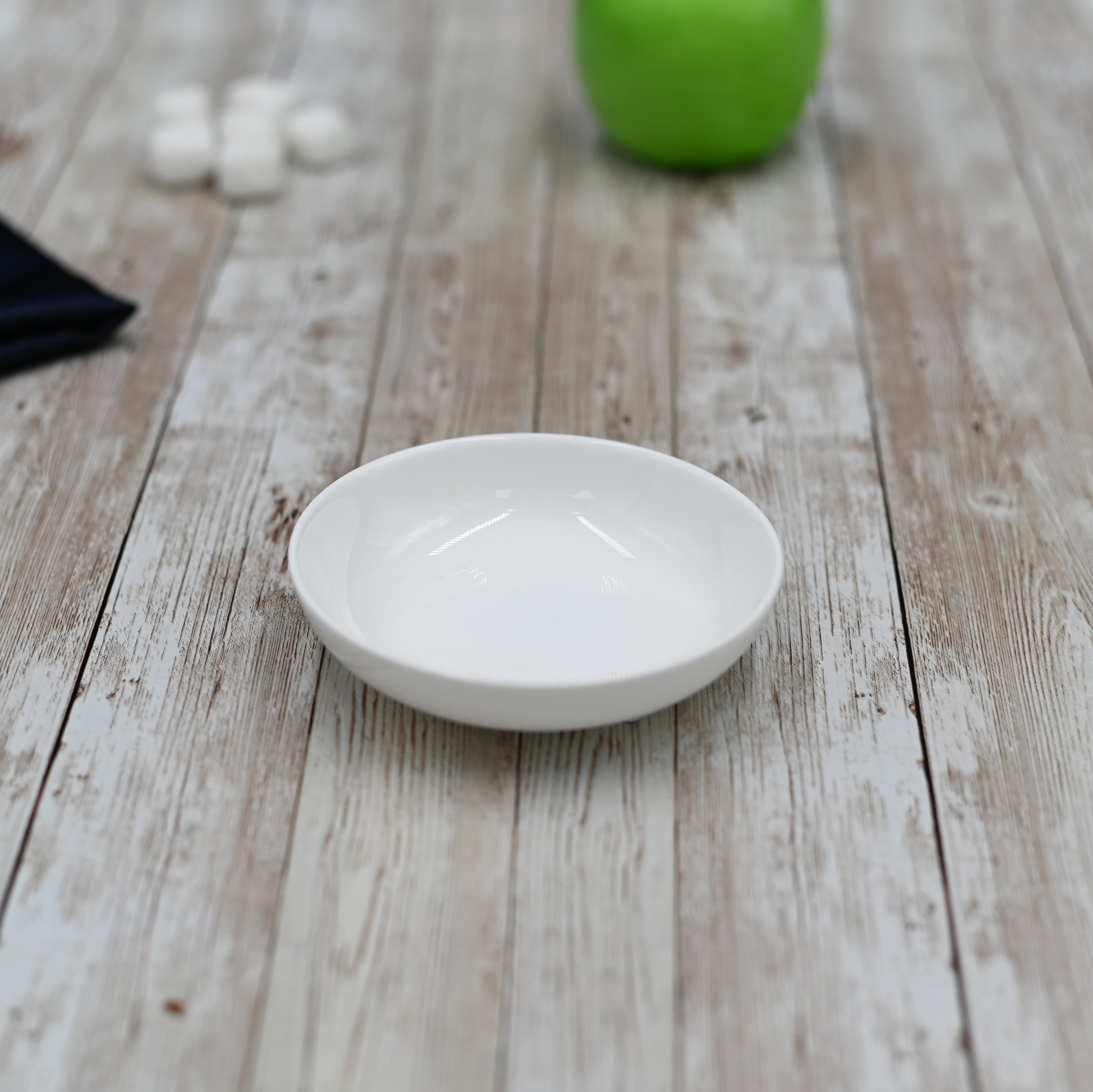 Round white soy dish measuring 4 inches, made of high-quality porcelain, perfect for sauces and appetizers.