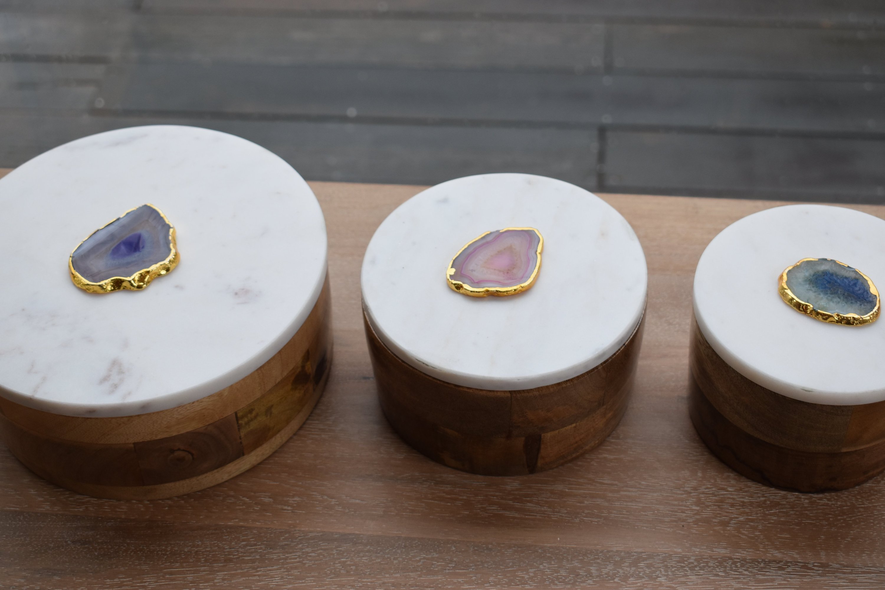 Round wooden box with a white marble lid and natural agate trim, elegantly designed for jewelry storage.