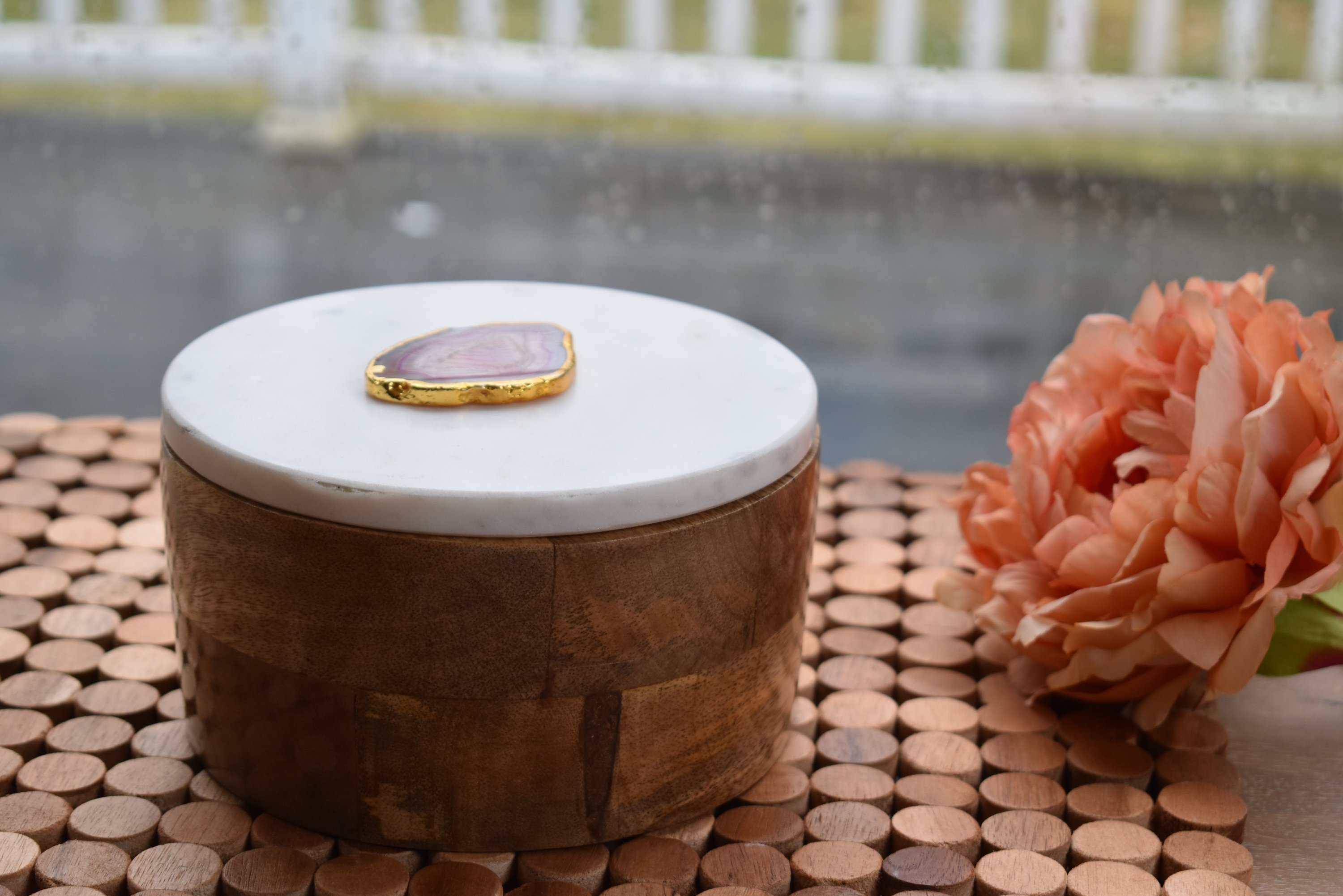 Round wooden box with a white marble lid and natural agate trim, elegantly designed for jewelry storage.