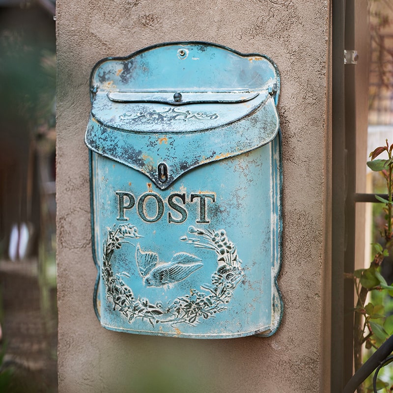 Rustic Blue Metal Mailbox in vibrant turquoise color, showcasing its charming design and durable metal construction.