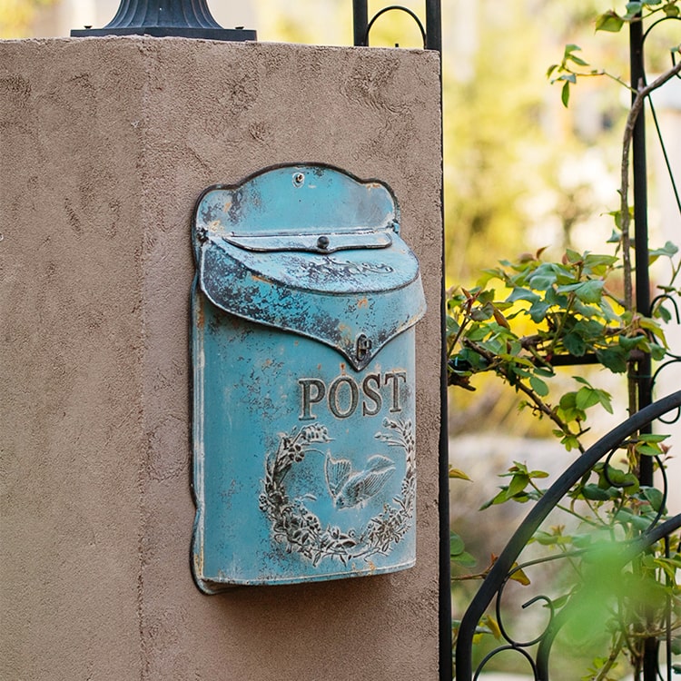 Rustic Blue Metal Mailbox in vibrant turquoise color, showcasing its charming design and durable metal construction.