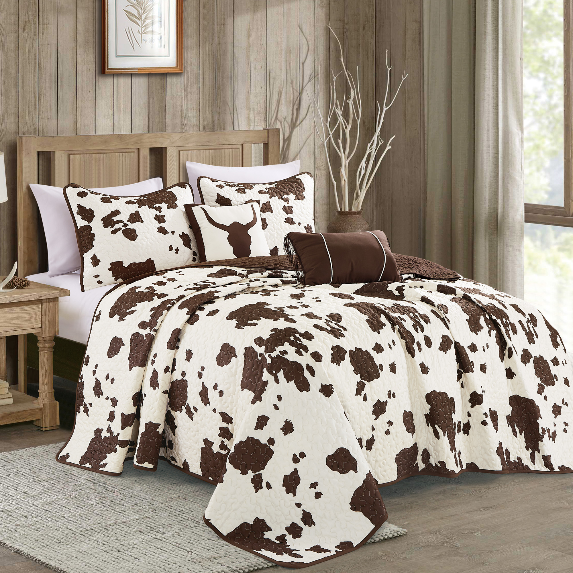 Rustic Cowhide Brown Cow Skull Quilt Set featuring a luxurious bedspread, pillow shams, and decorative pillows in a Western design.