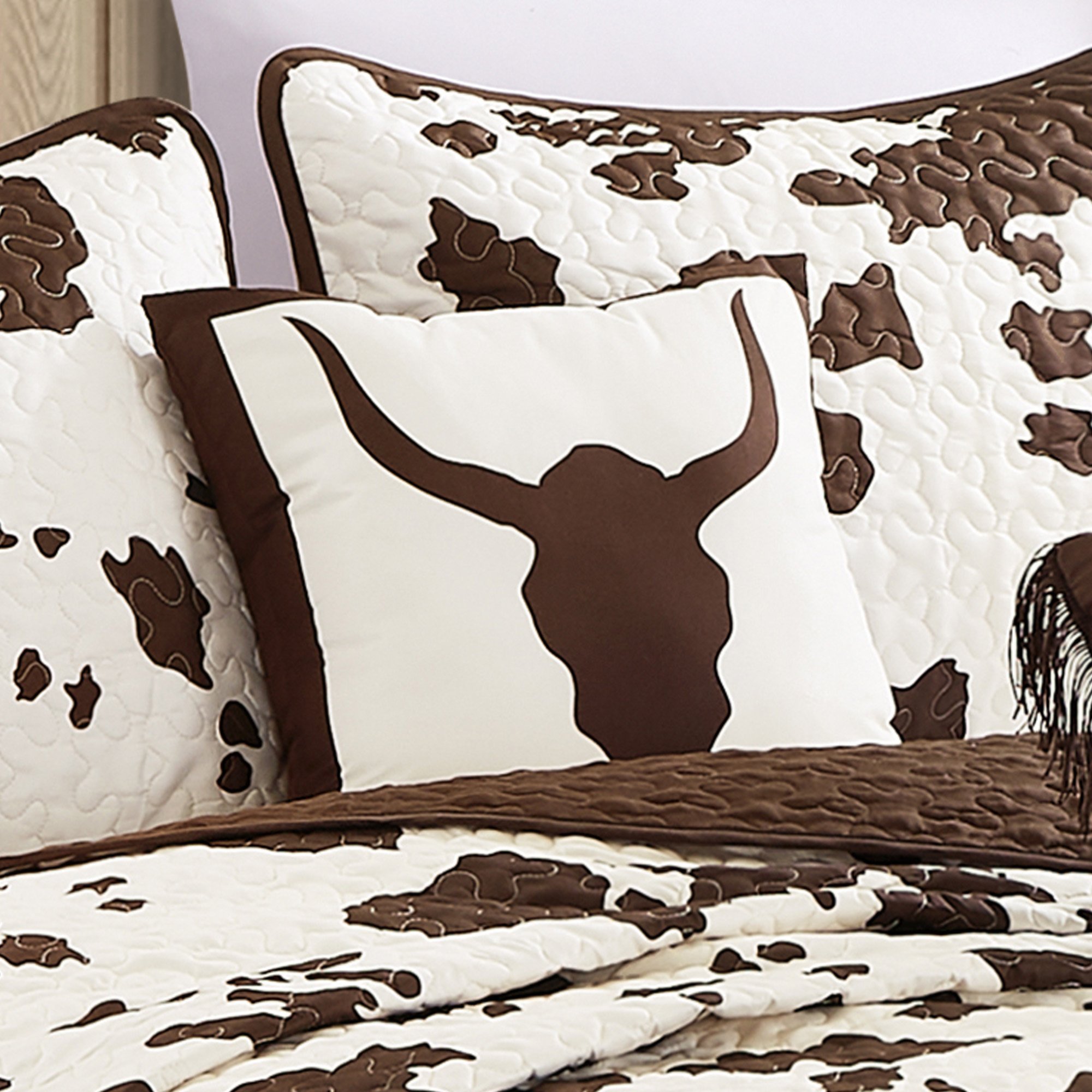 Rustic Cowhide Brown Cow Skull Quilt Set featuring a luxurious bedspread, pillow shams, and decorative pillows in a Western design.