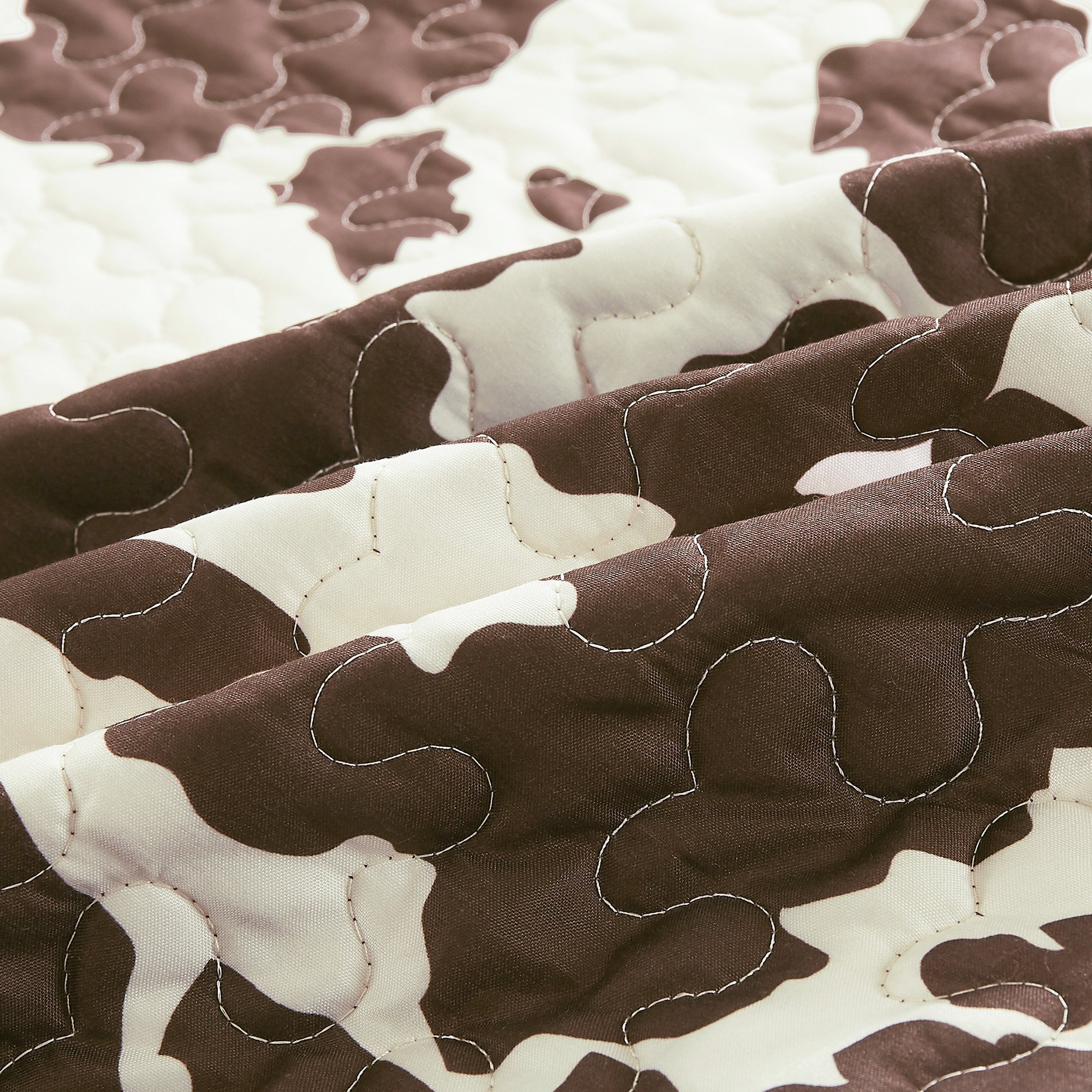 Rustic Cowhide Brown Cow Skull Quilt Set featuring a luxurious bedspread, pillow shams, and decorative pillows in a Western design.