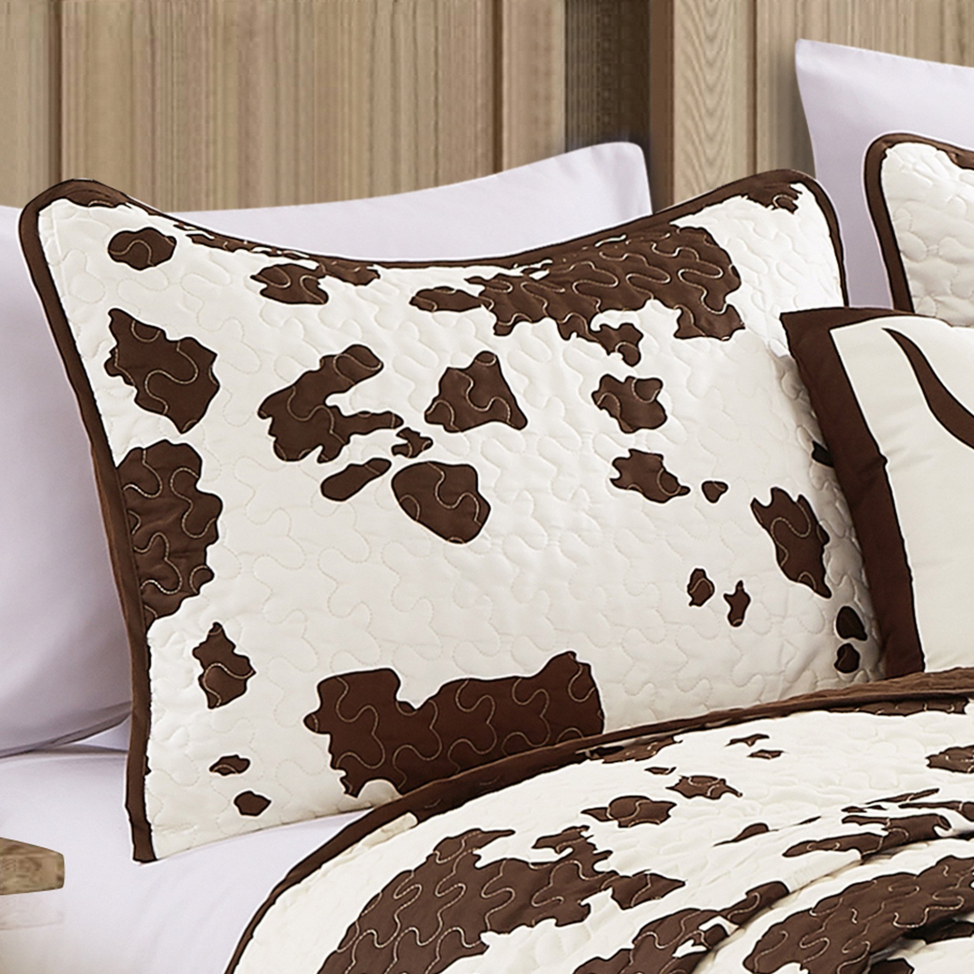 Rustic Cowhide Brown Cow Skull Quilt Set featuring a luxurious bedspread, pillow shams, and decorative pillows in a Western design.