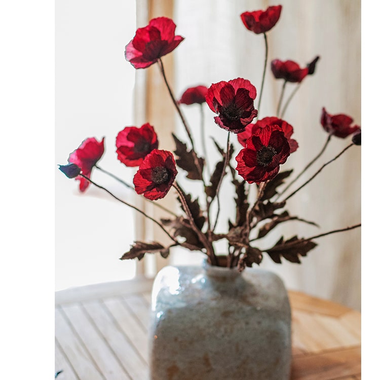 A 23-inch tall Rustic Poppy Flower Stem in dark red with three blooms and one bud, featuring green leaves, perfect for home decor.